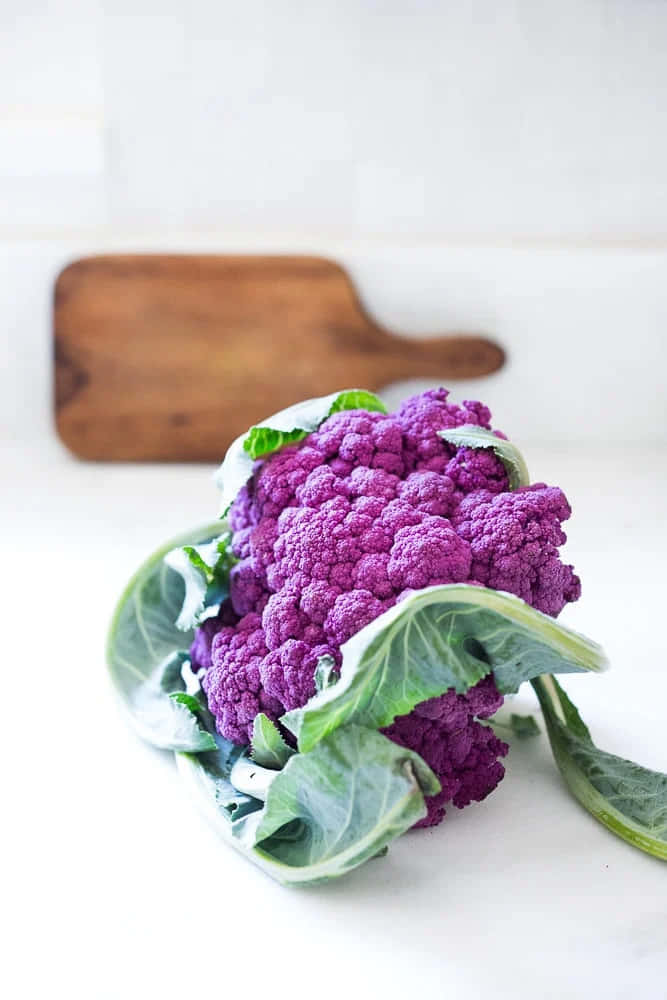 purple cauliflower, white surface, wooden cutting board, SD Phone Wallpaper