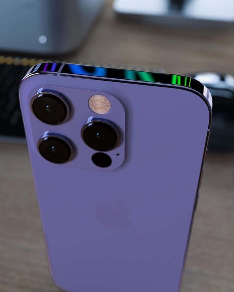 Purple iPhone 14 Pro Max, rainbow-colored edge, wooden desk, SD Phone Wallpaper