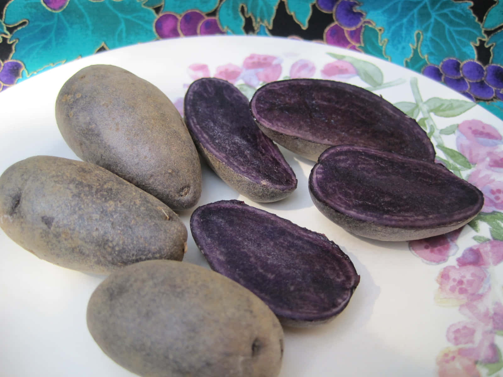 Purple-skinned potatoes, vibrant violet flesh, floral plate, HD Desktop Wallpaper