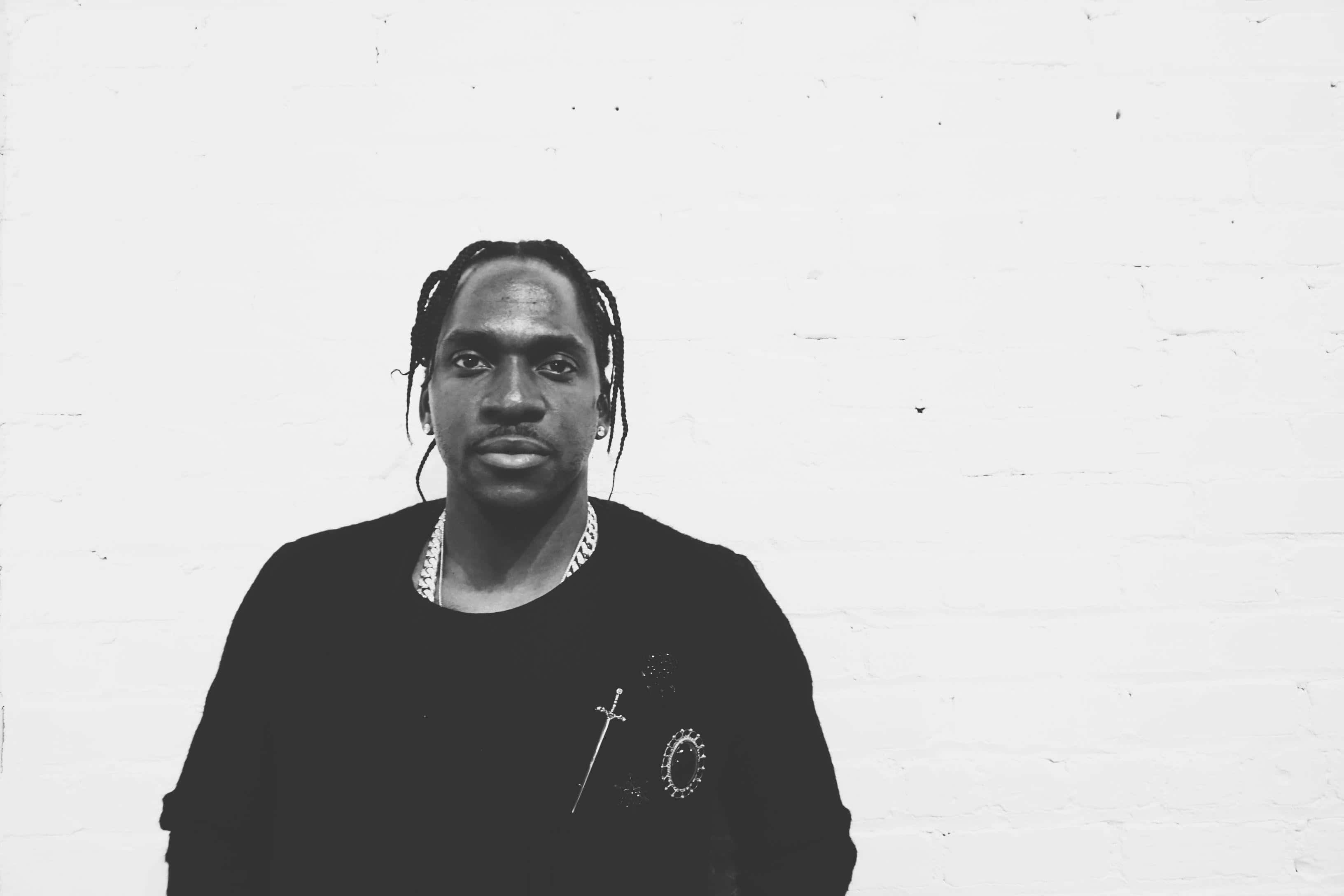 Pusha T, black shirt, sword and circle embroidery, 2K Desktop Wallpaper
