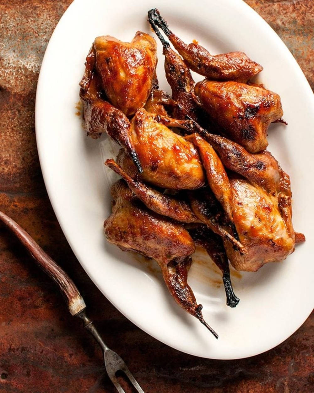 fried quail legs platter, caramelized glaze, white oval plate, SD Phone Wallpaper