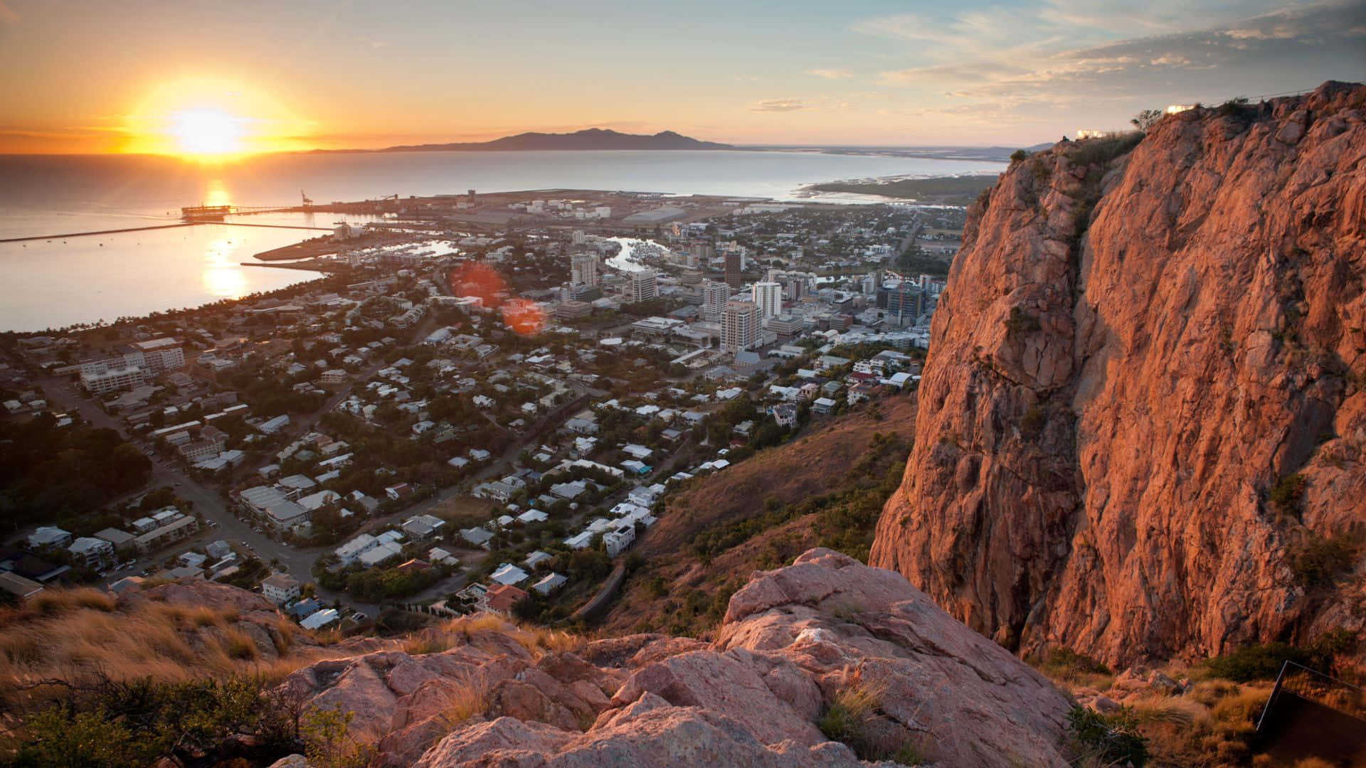 Sunset, coastal city, rugged cliff, Full HD Desktop Wallpaper