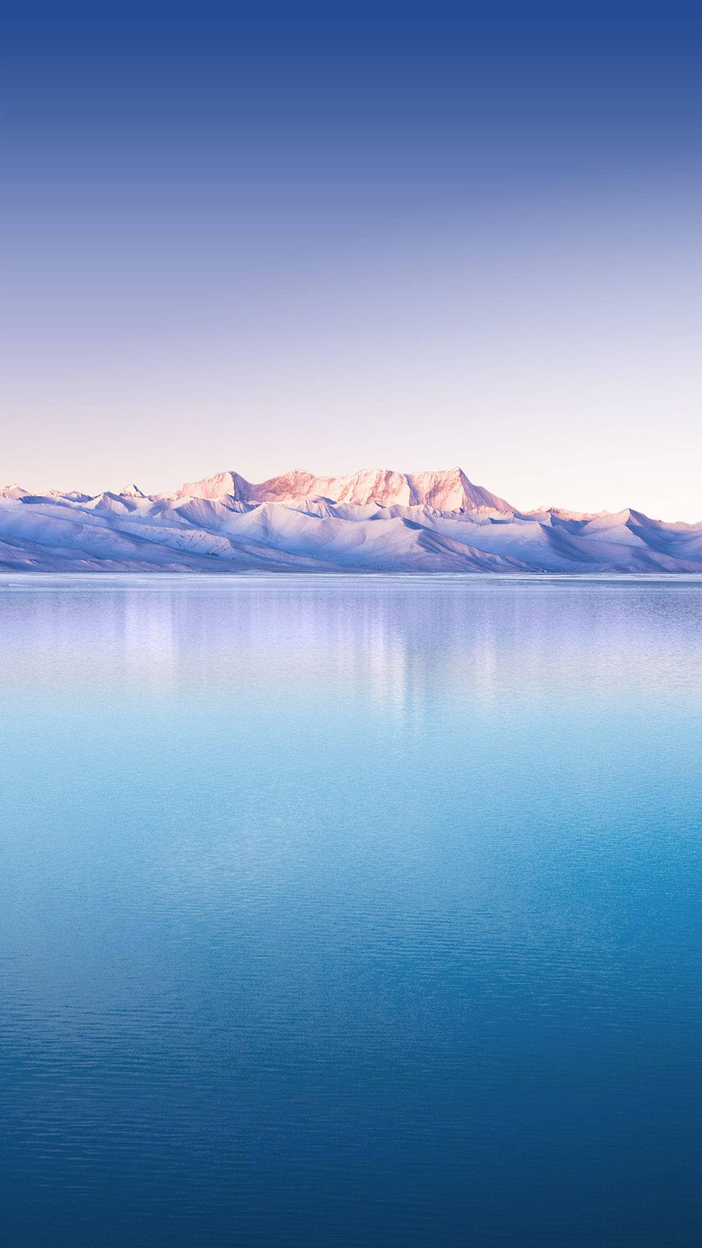 mountain range, calm blue waters, soft gradient sky, 2K Phone Wallpaper