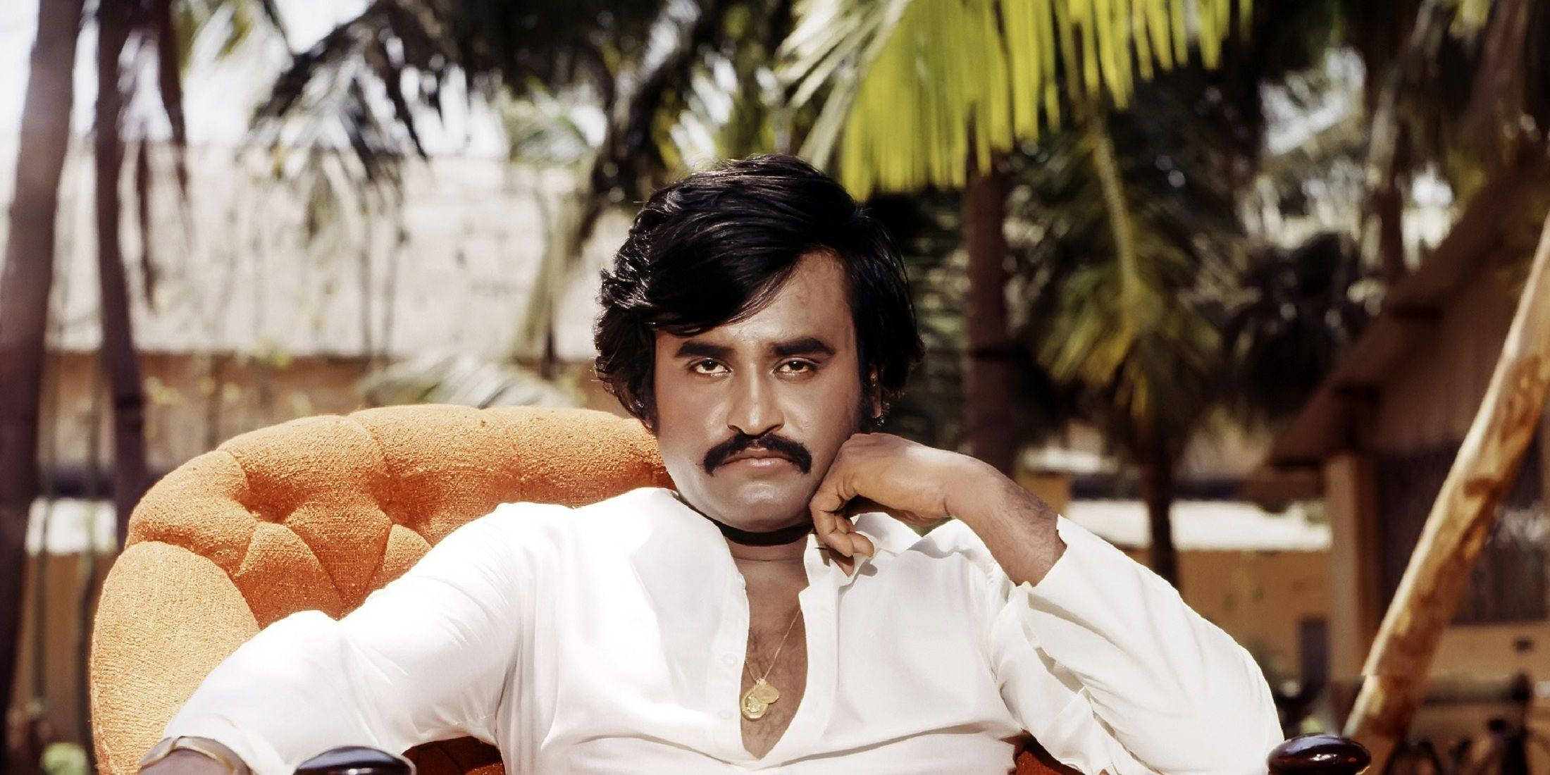 Rajinikanth, orange tufted chair, palm trees, Full HD Desktop Wallpaper