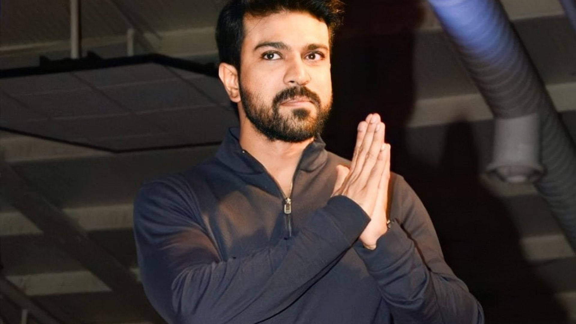 Ram Charan, hands pressed together, dark zip-neck top, Full HD Desktop Wallpaper