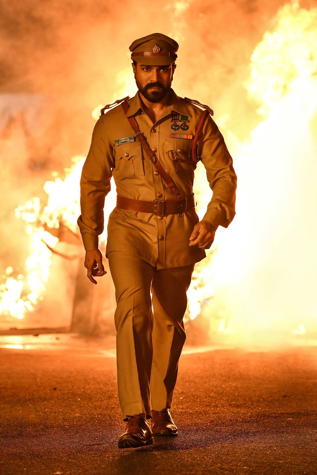 Ram Charan, khaki uniform, fiery explosions, HD Phone Wallpaper