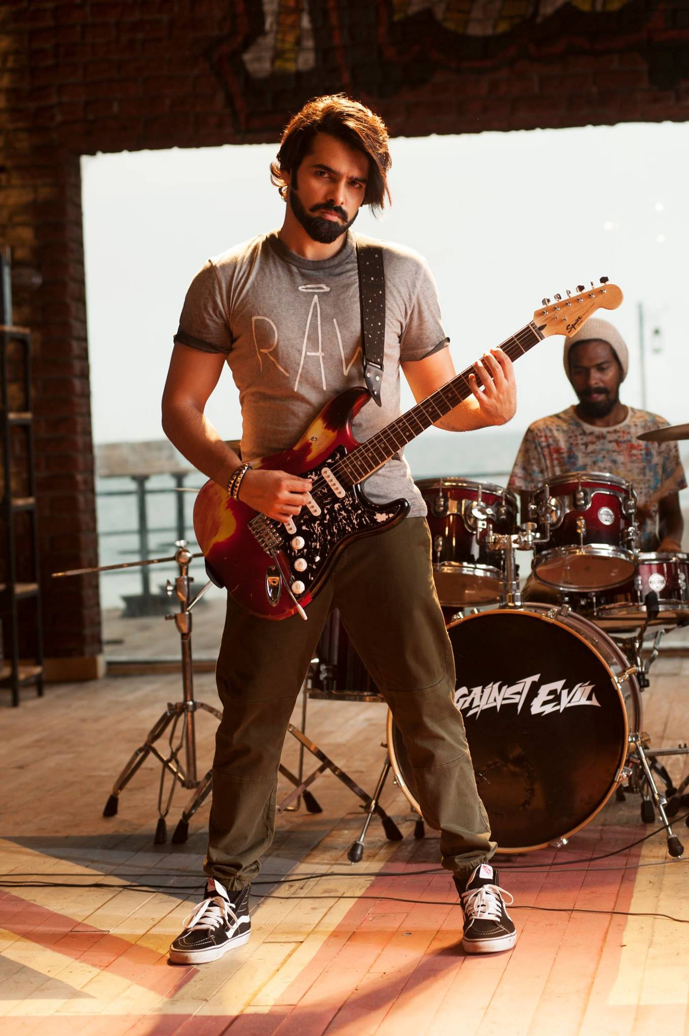 Ram Pothineni, red electric guitar, sunlit wooden stage, Full HD Phone Wallpaper
