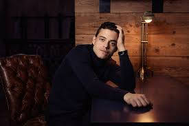 Rami Malek, dark turtleneck, wooden table, SD Desktop Wallpaper