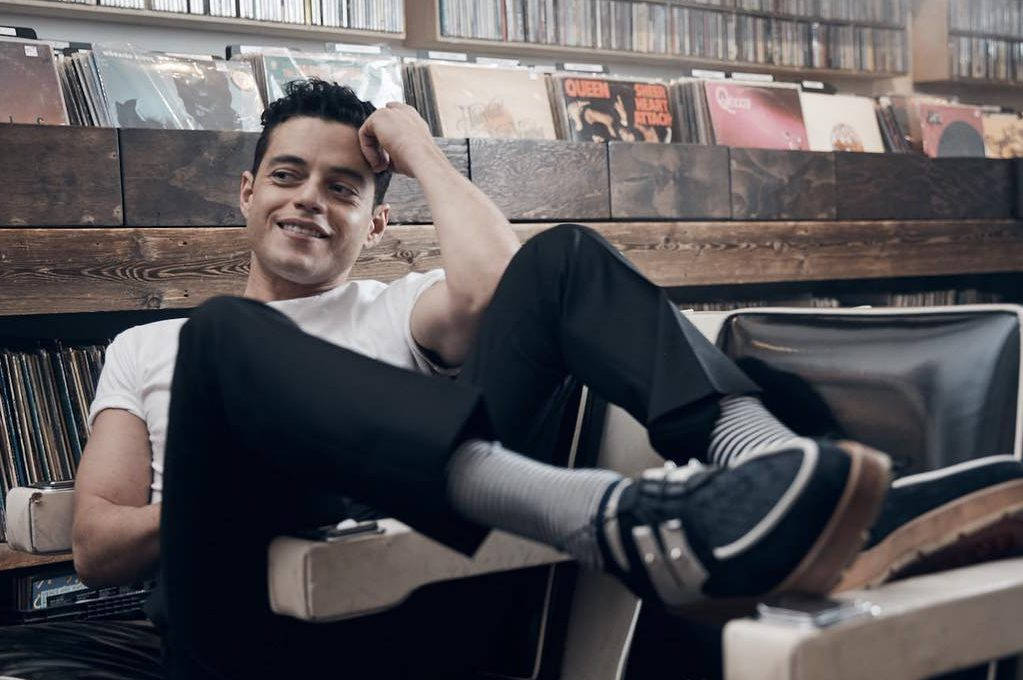 Rami Malek, vintage chair, wooden shelves, SD Desktop Wallpaper