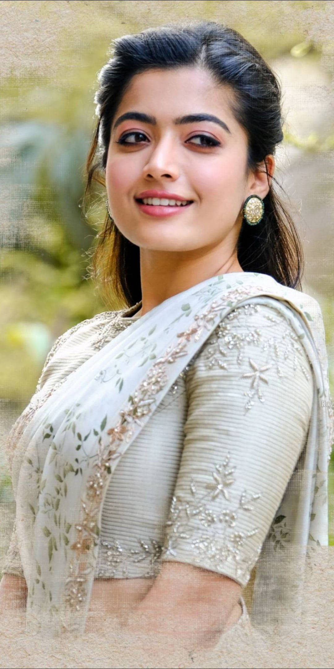 Rashmika Mandanna, cream embroidered sari, blurred green garden backdrop, Full HD Phone Wallpaper