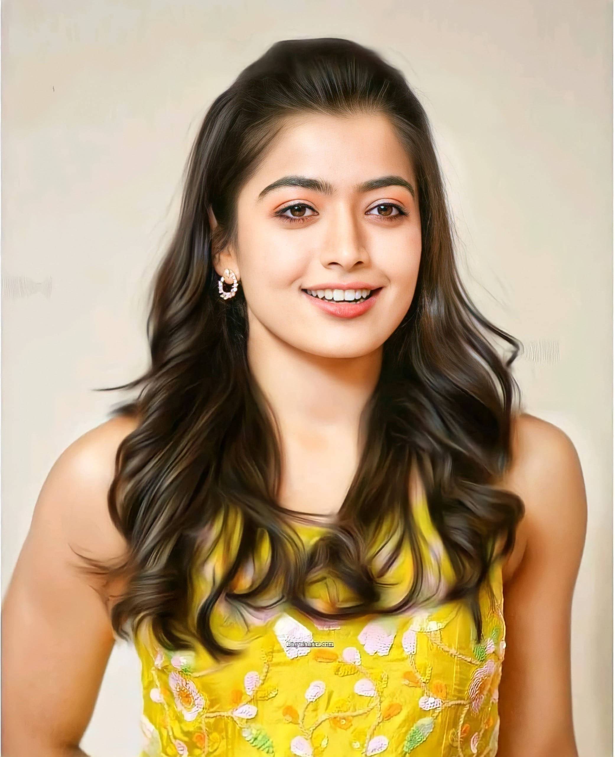 Rashmika Mandanna, long wavy dark hair, vibrant yellow floral top, 2K Phone Wallpaper