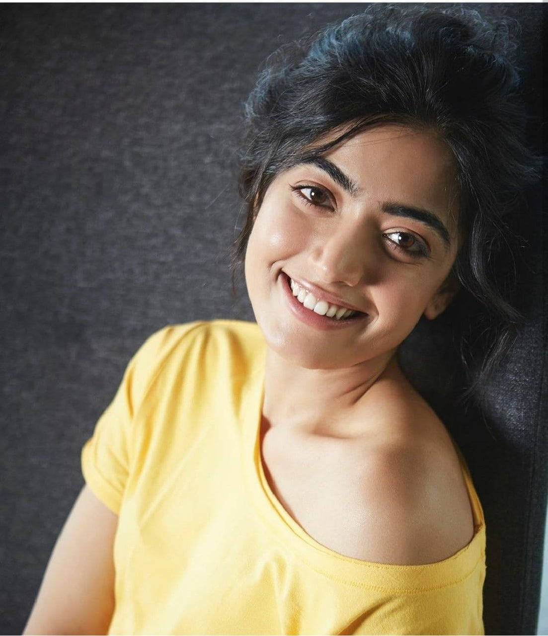 Rashmika Mandanna, yellow off-shoulder t-shirt, dark curly hair, HD Phone Wallpaper