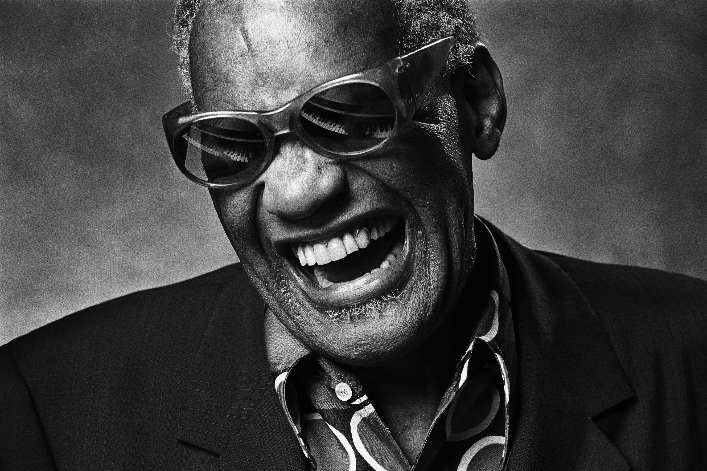 Ray Charles, black and white portrait, man laughing widely, 2K Desktop Wallpaper