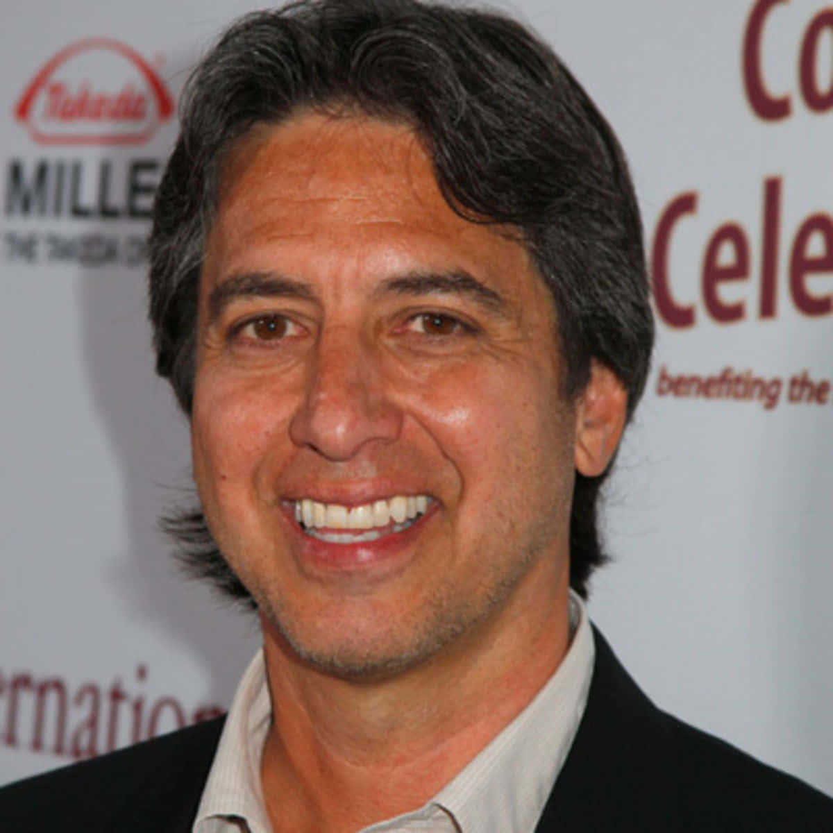 Ray Romano, black suit, branded event backdrop, SD Desktop Wallpaper
