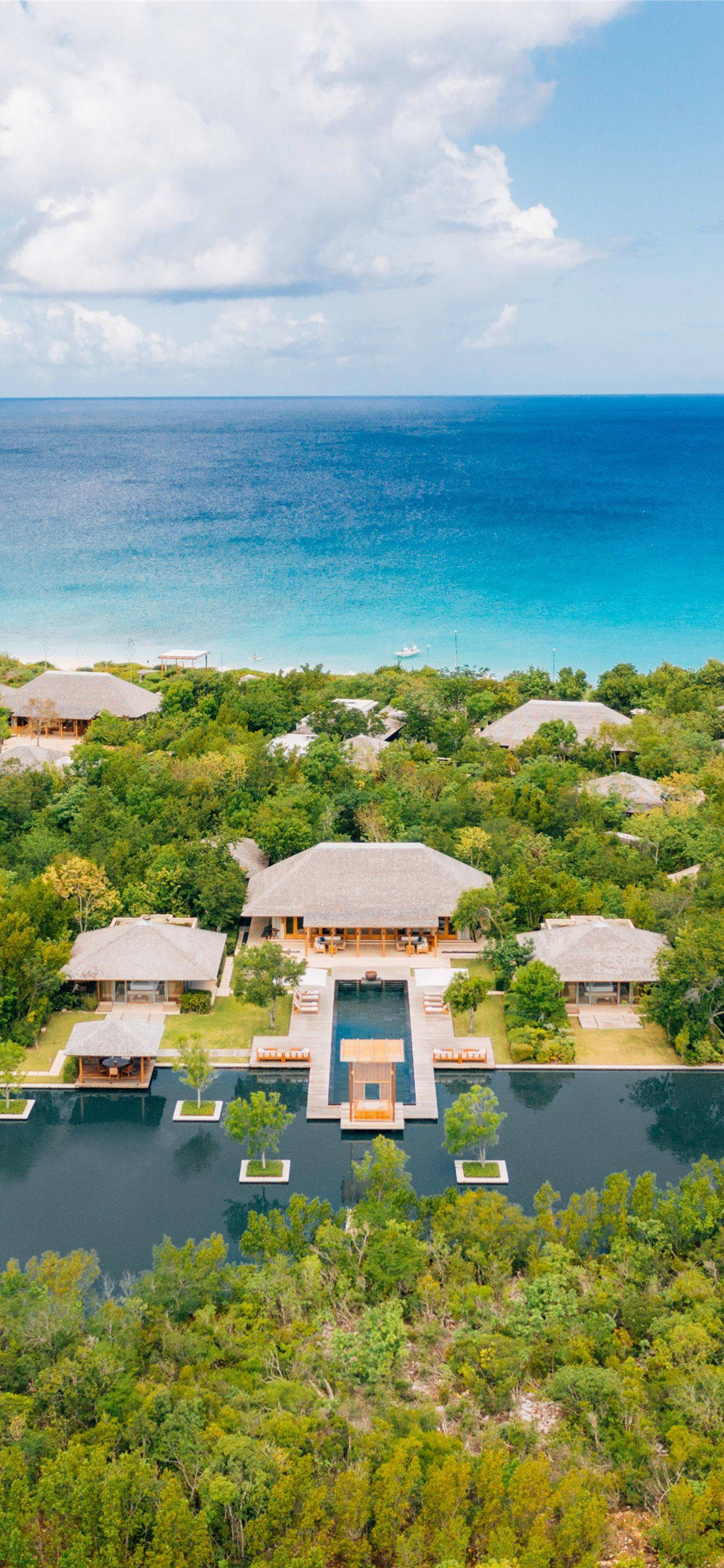 luxury resort villas, thatched roofs, lush greenery, 2K Phone Wallpaper