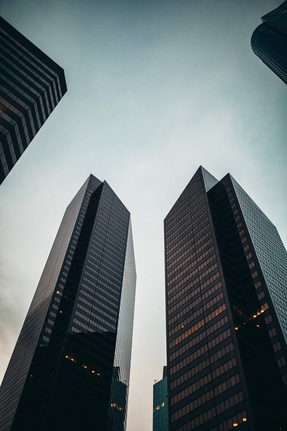 tall black buildings, towering skyscrapers, pale sky, HD Phone Wallpaper