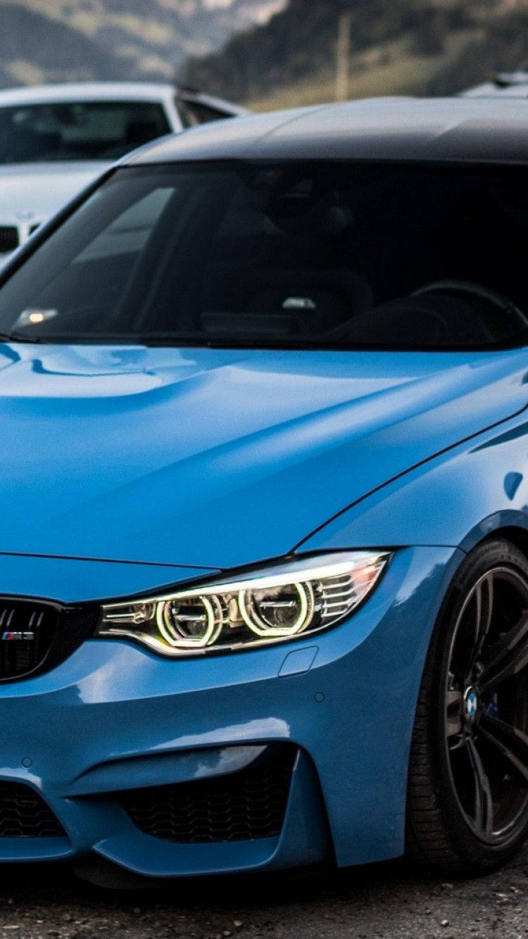 blue BMW M4, glowing headlights, mountainous backdrop, HD Phone Wallpaper