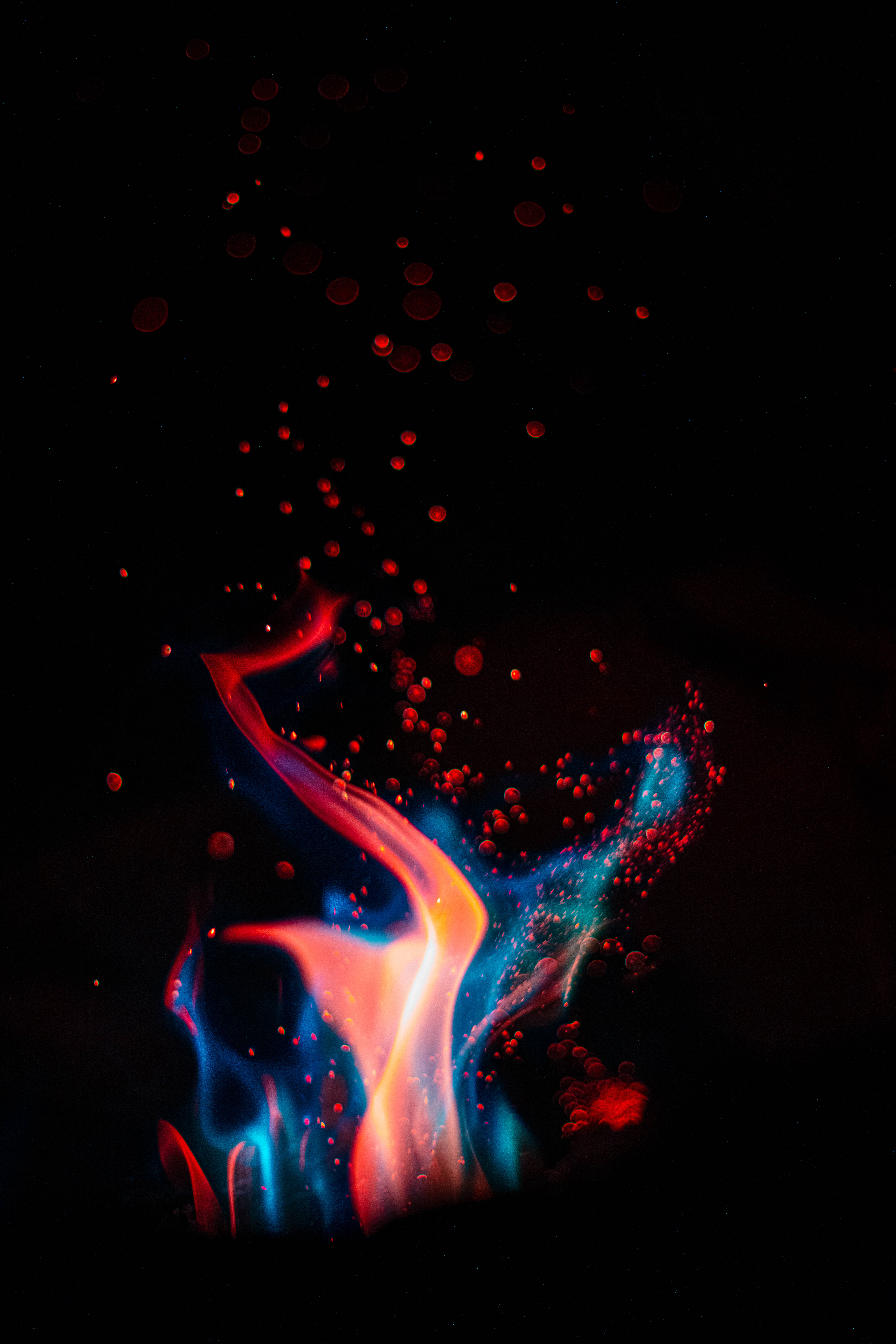 iPhone Fire, blue sparks, vibrant red and blue flame-like tendrils, 8K Phone Wallpaper