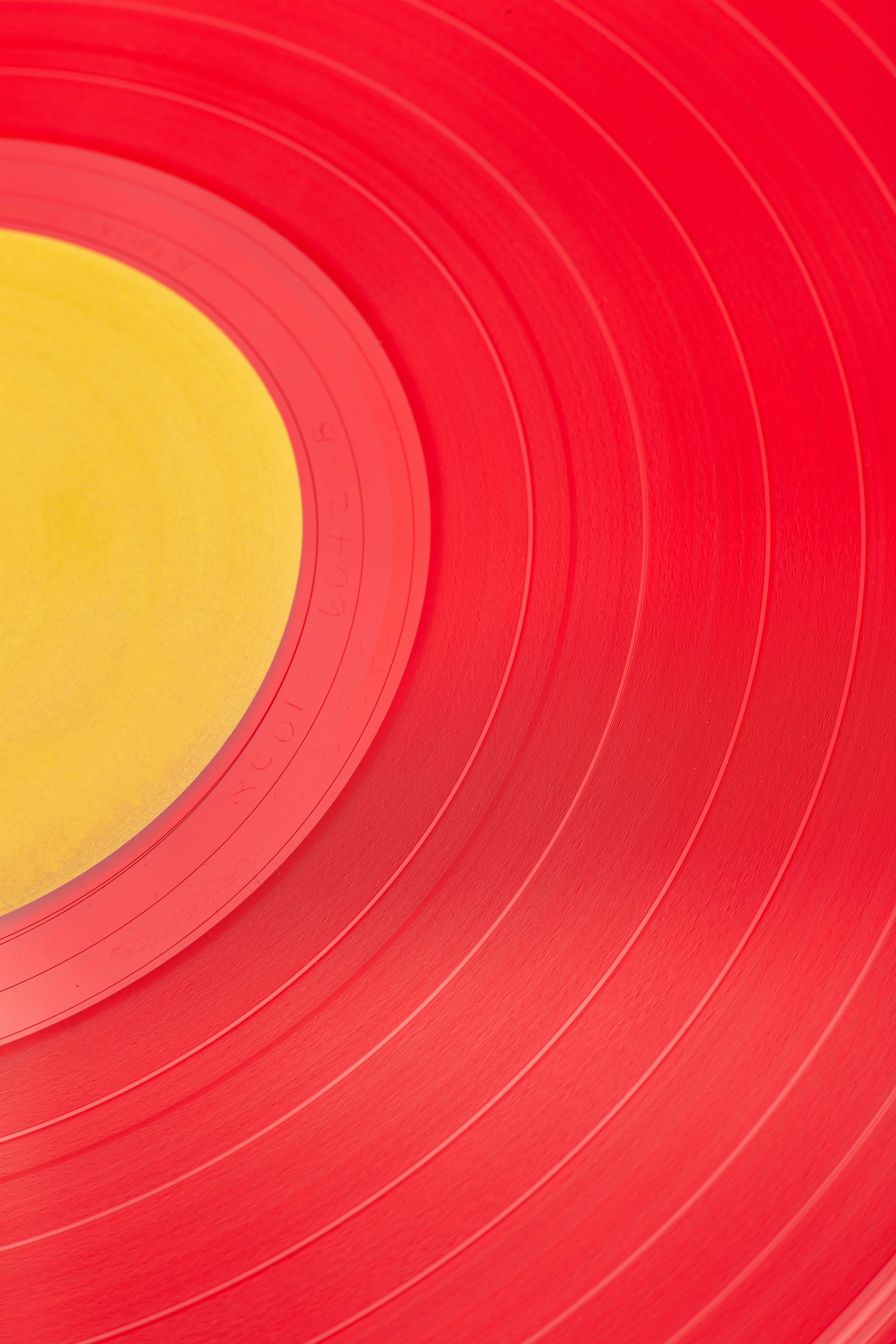 red vinyl record, yellow center label, concentric grooves, 5K Phone Wallpaper