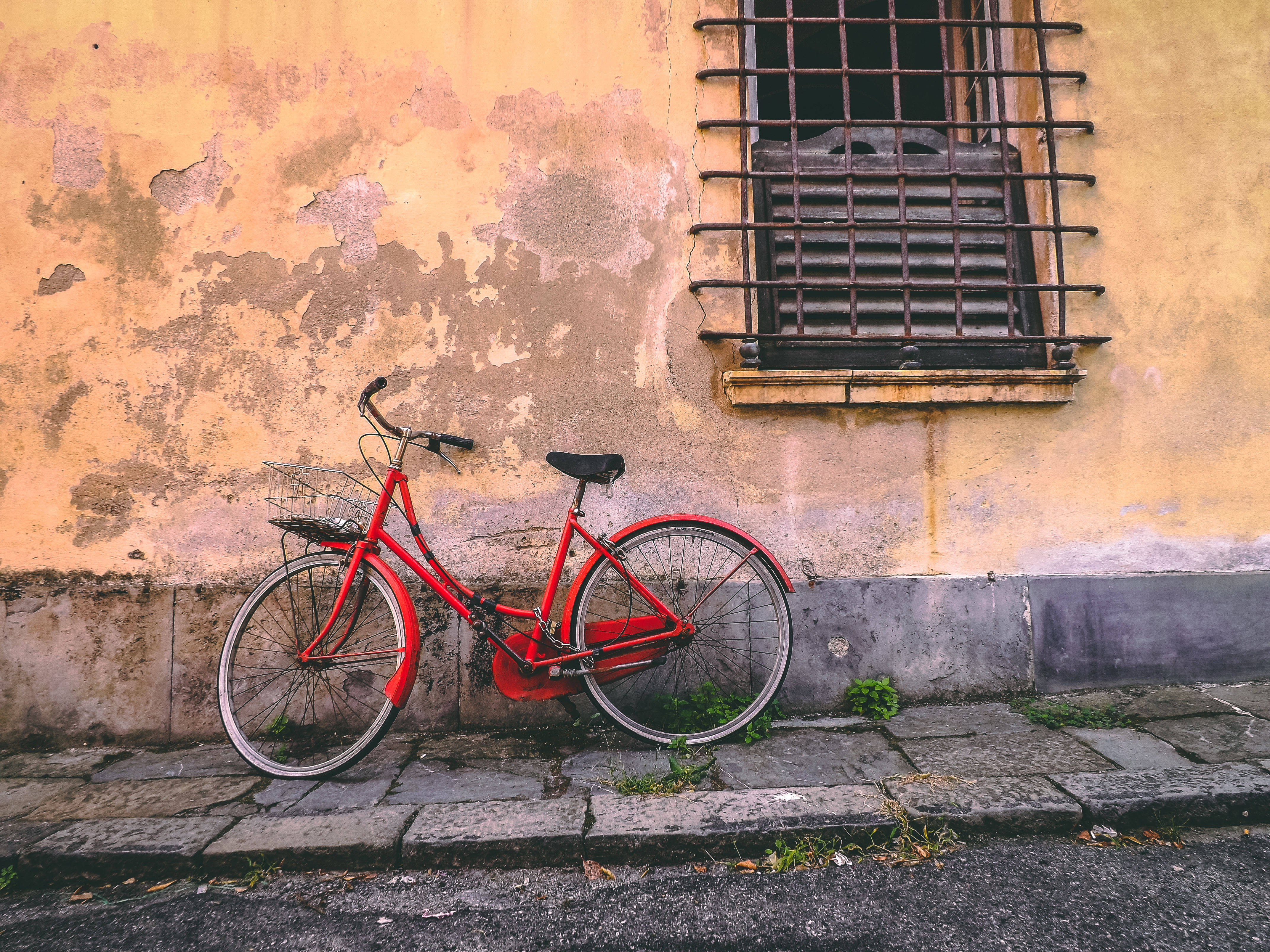 Red Bike, weathered ochre wall, barred window, 4K Desktop Wallpaper