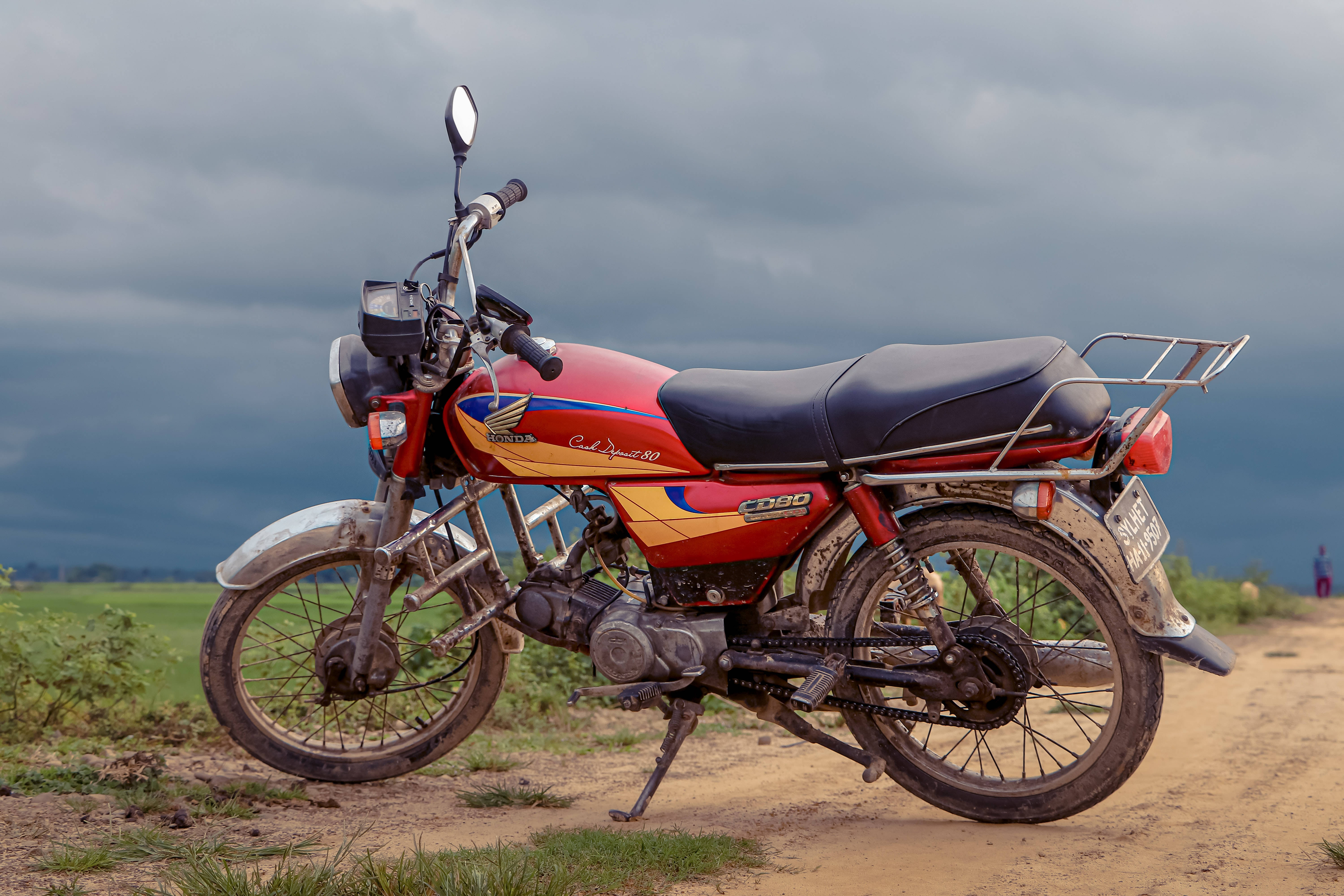 red and yellow motorcycle, dirt road, cloudy sky, 5K Desktop Wallpaper