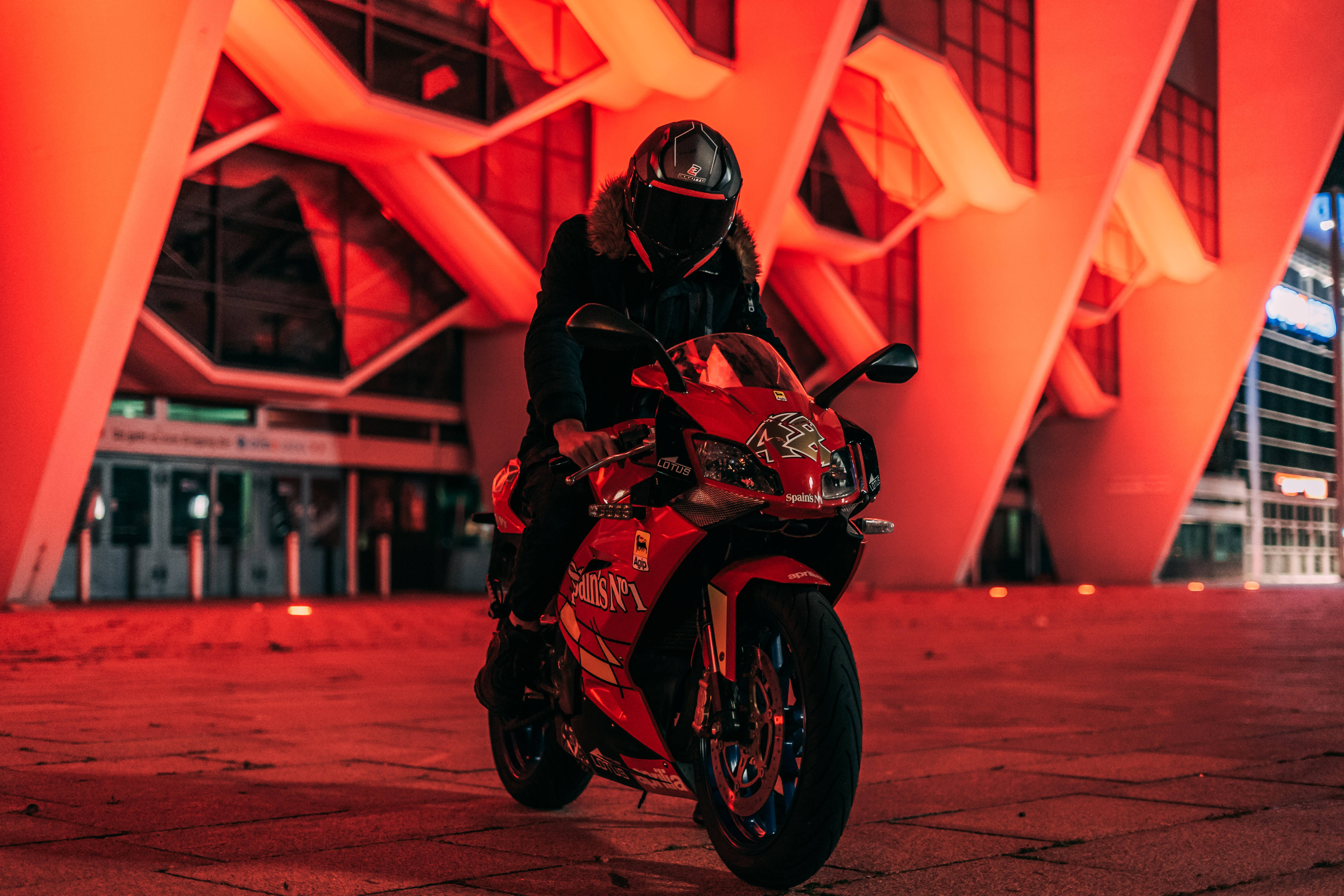 red sport motorcycle, glowing orange geometric building, night, 5K Desktop Wallpaper