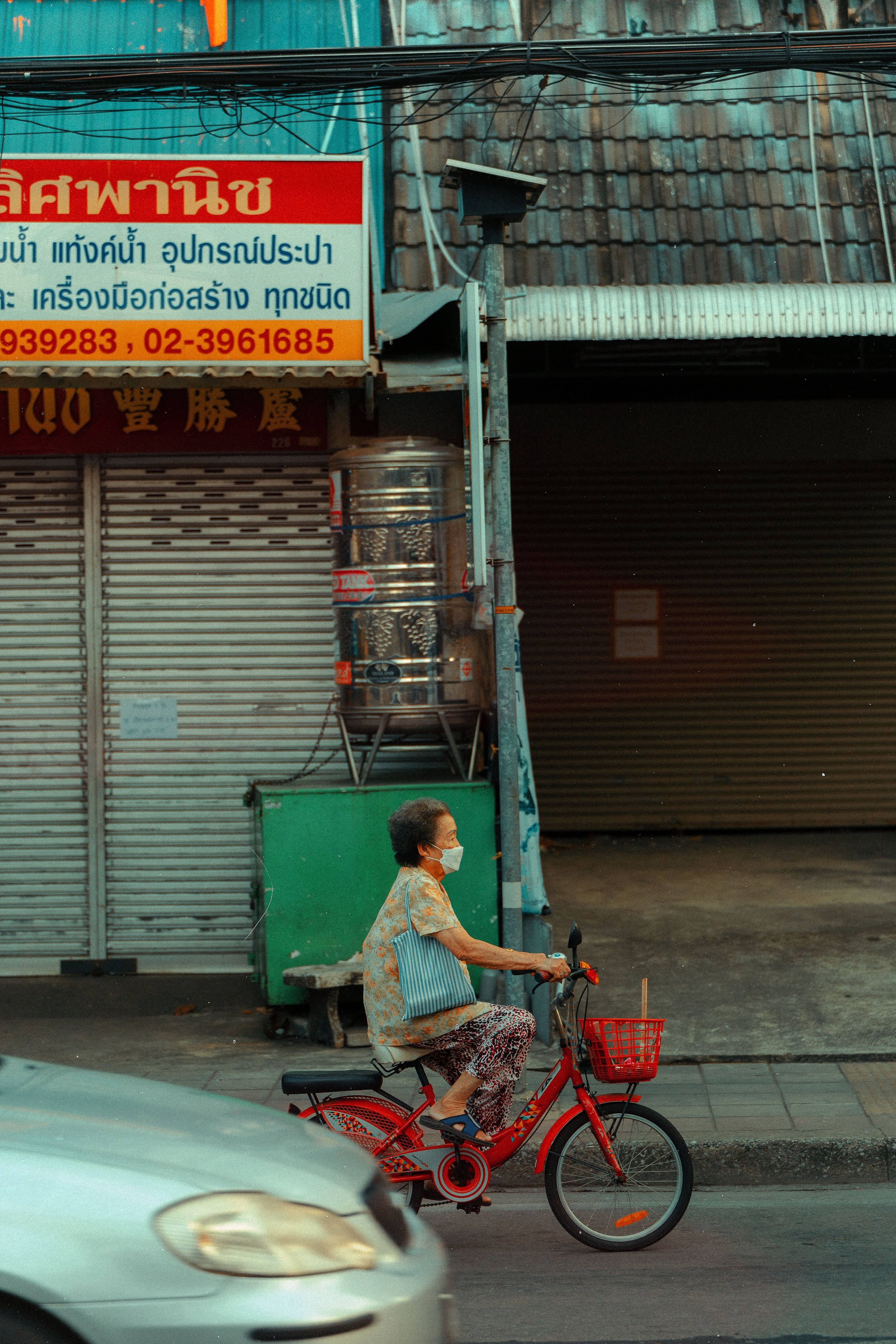 old woman, red bicycle, shuttered shops, 4K Phone Wallpaper