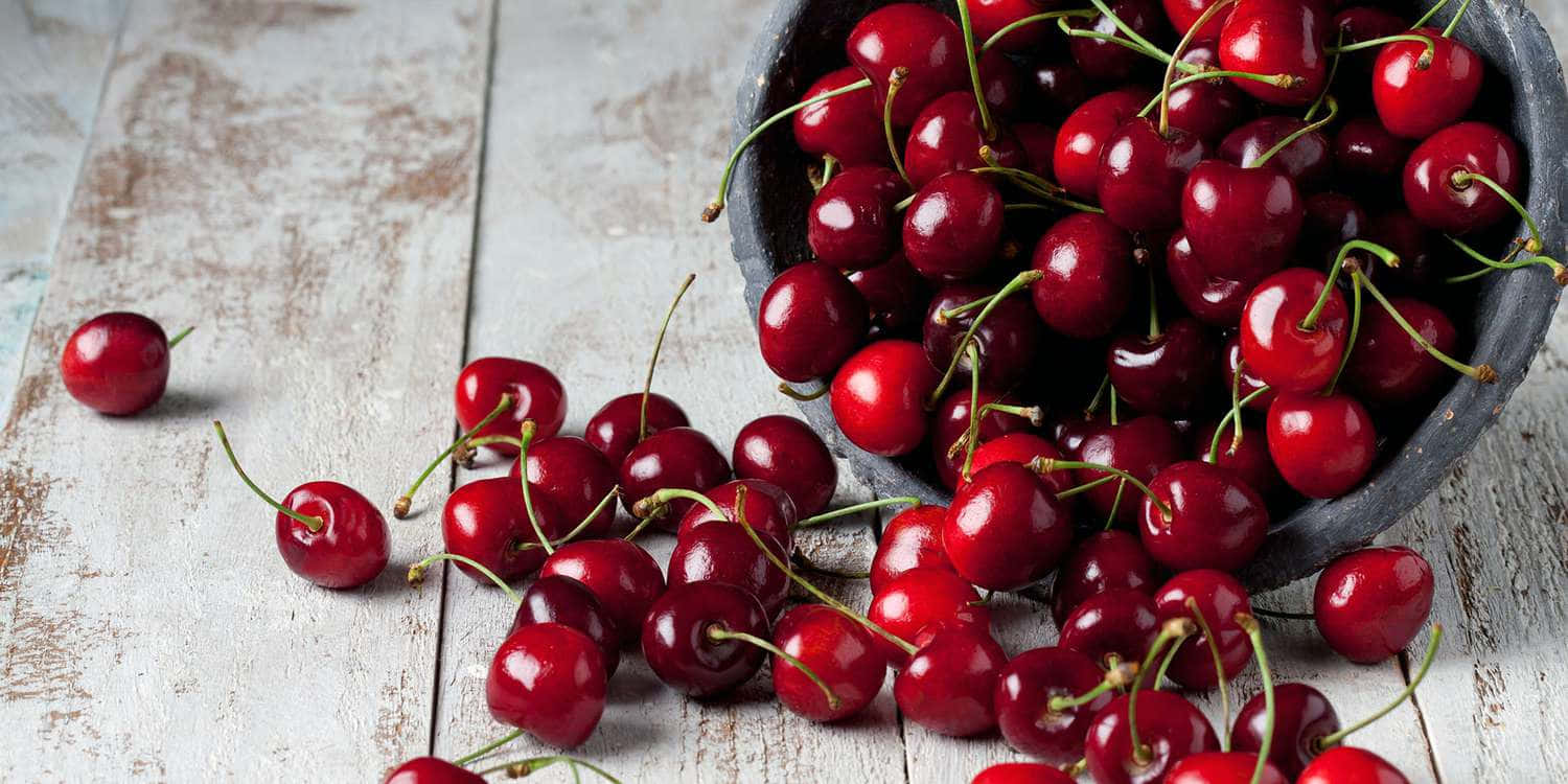 vibrant red cherries, dark bowl, weathered white wooden surface, HD Desktop Wallpaper