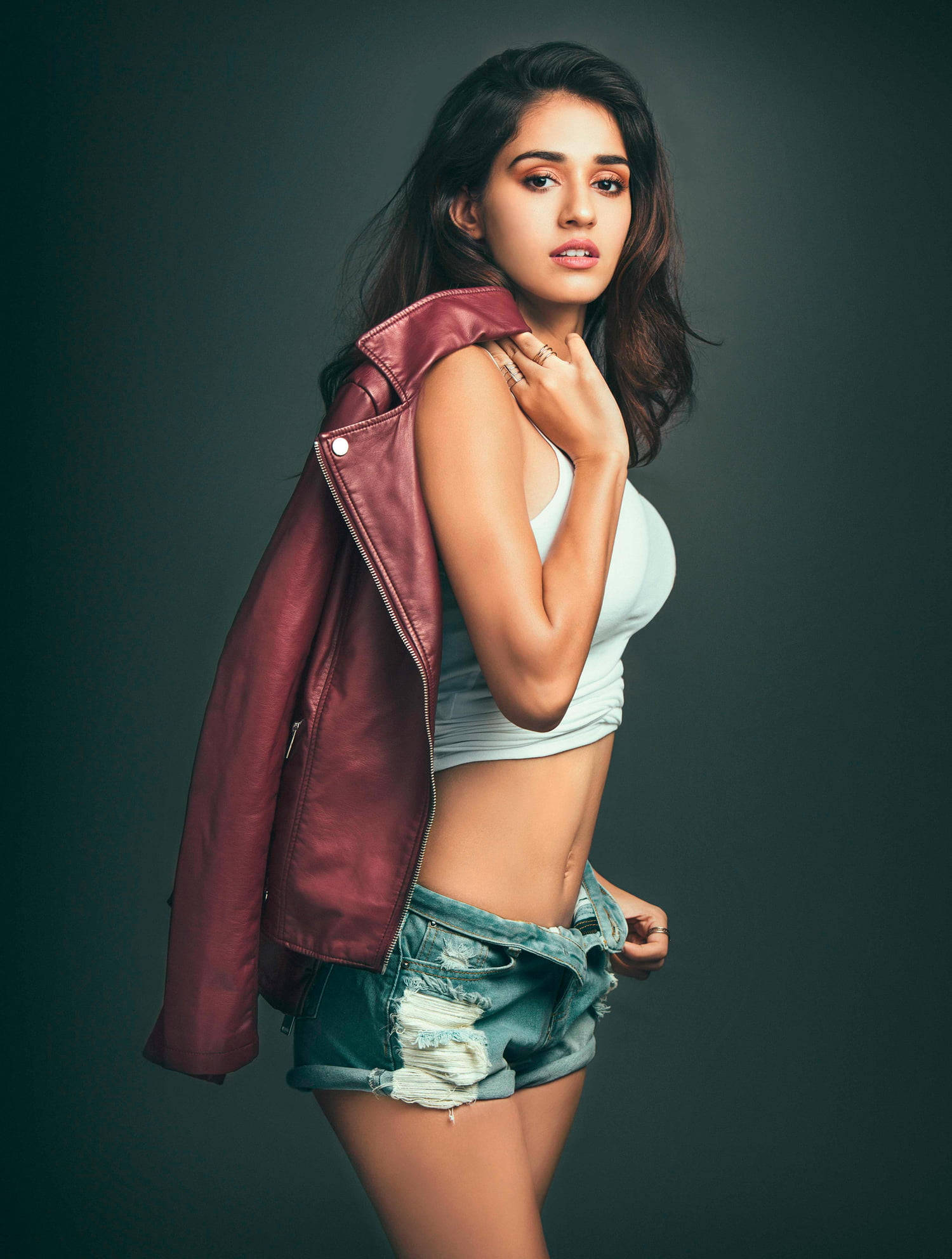 maroon leather jacket, ripped denim shorts, dark studio backdrop, Full HD Phone Wallpaper