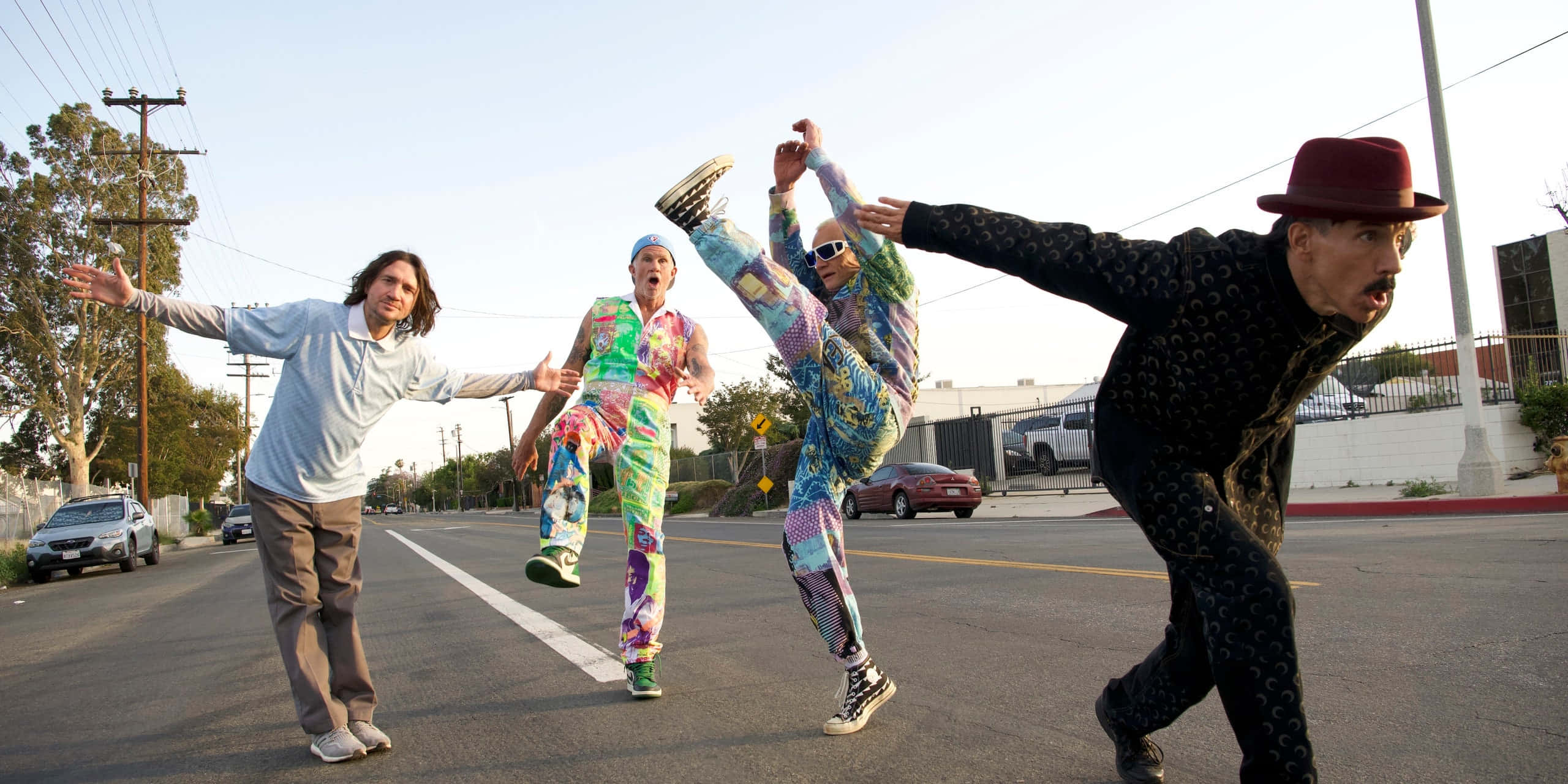 Red Hot Chili Peppers, colorful onesies, sunlit urban street, 2K Desktop Wallpaper