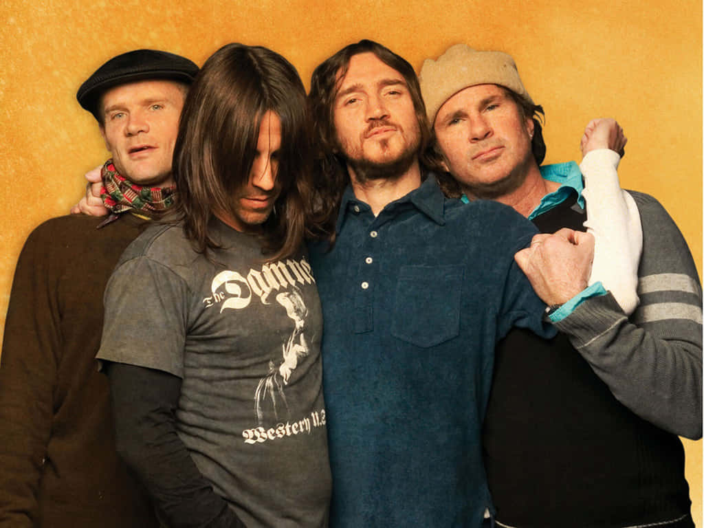 Red Hot Chili Peppers, dark clothing, warm yellow textured wall, SD Desktop Wallpaper