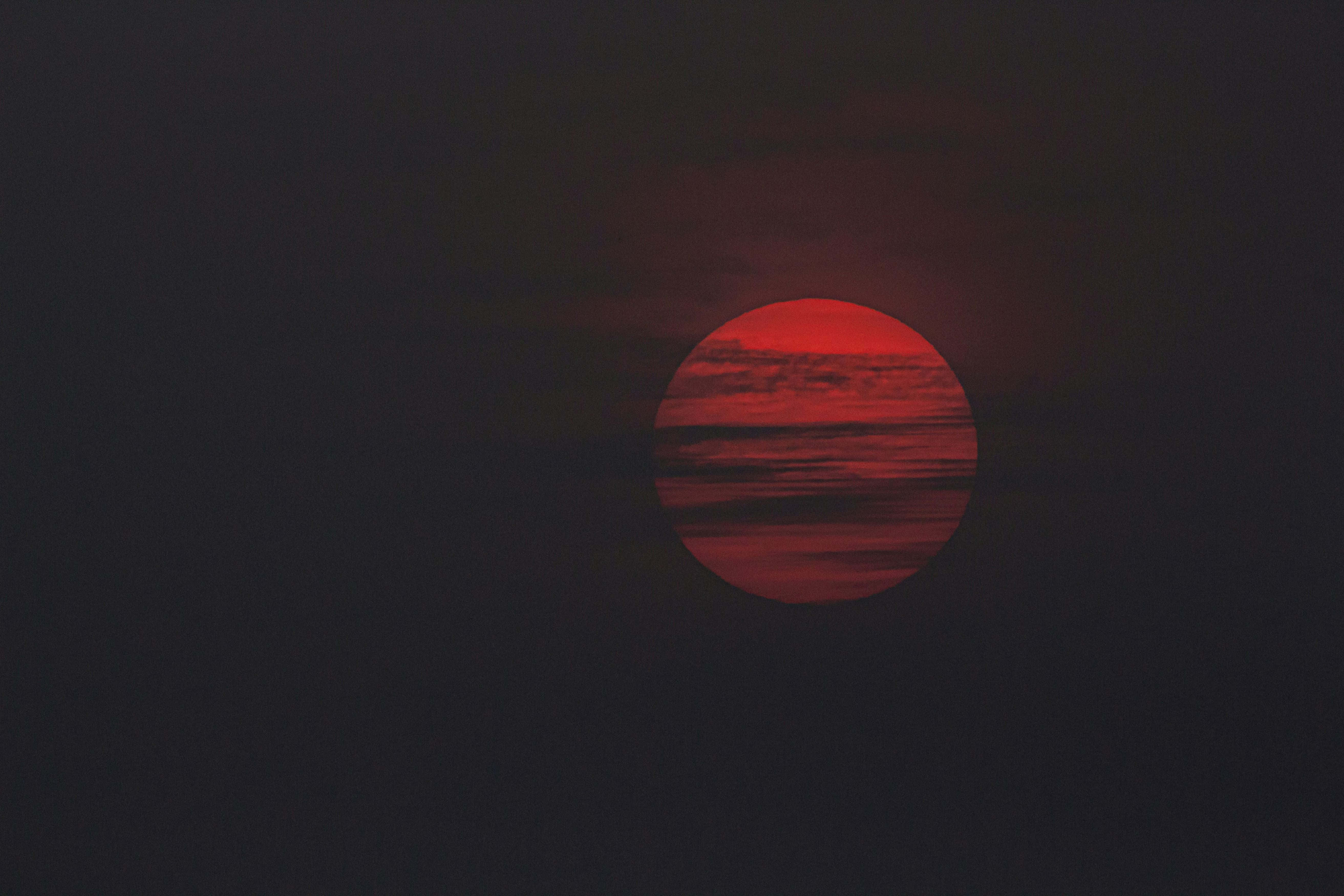 crimson sunset glow, blood red sun, dark clouds, 5K Desktop Wallpaper