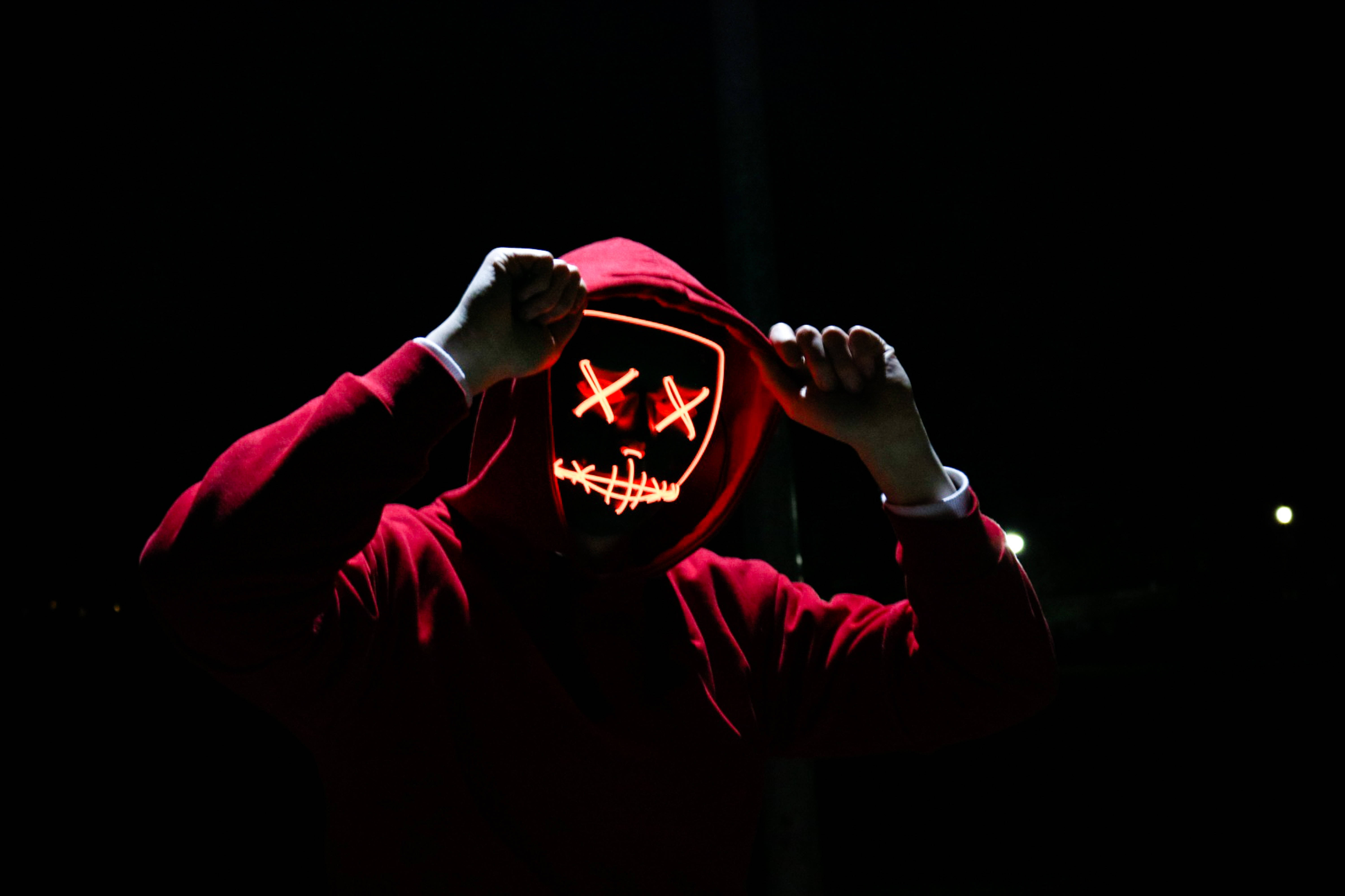 red hoodie, glowing orange LED mask, X eyes, 5K Desktop Wallpaper