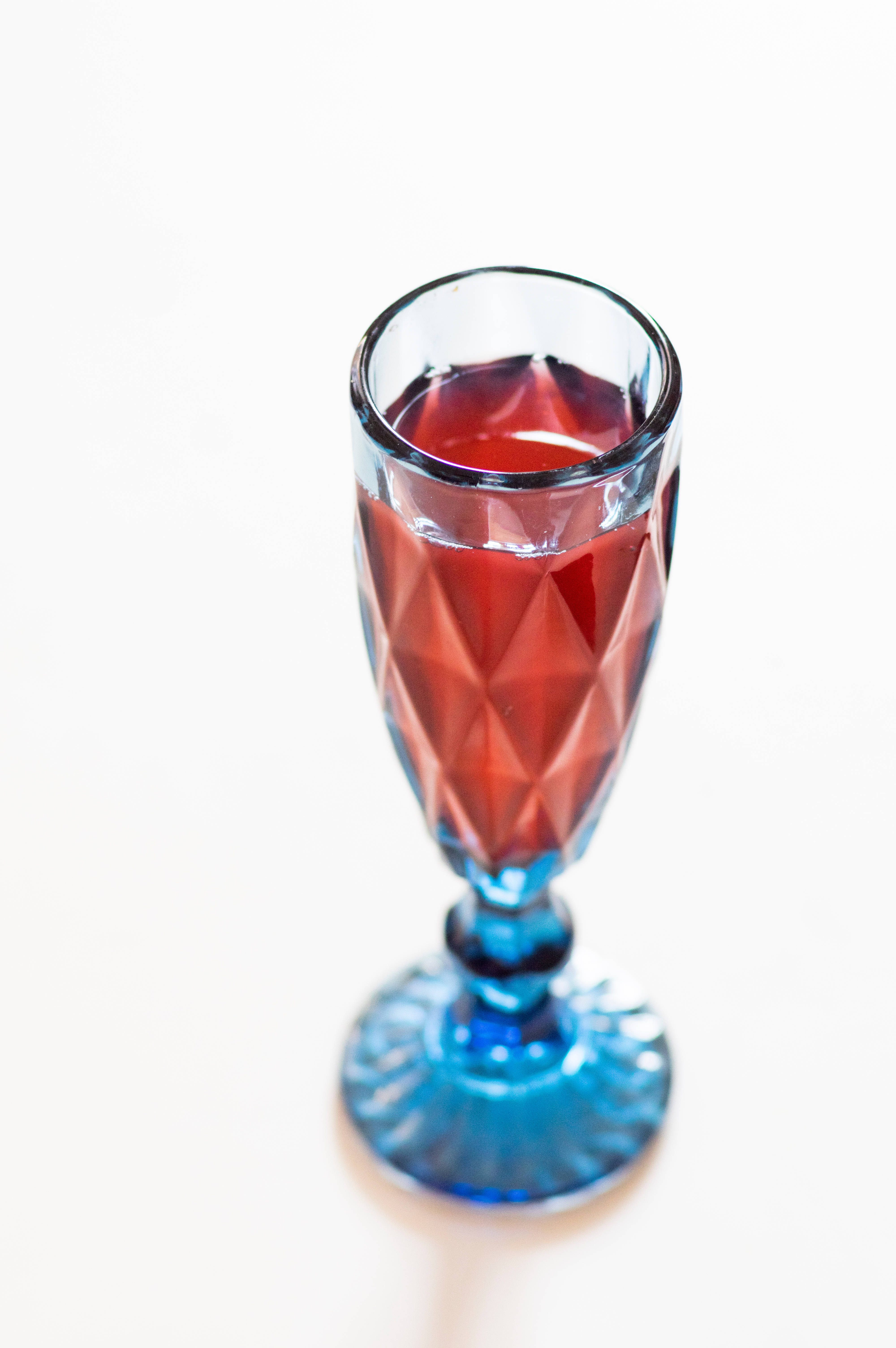 transparent wine glass, faceted blue glass, red liquid, 5K Phone Wallpaper