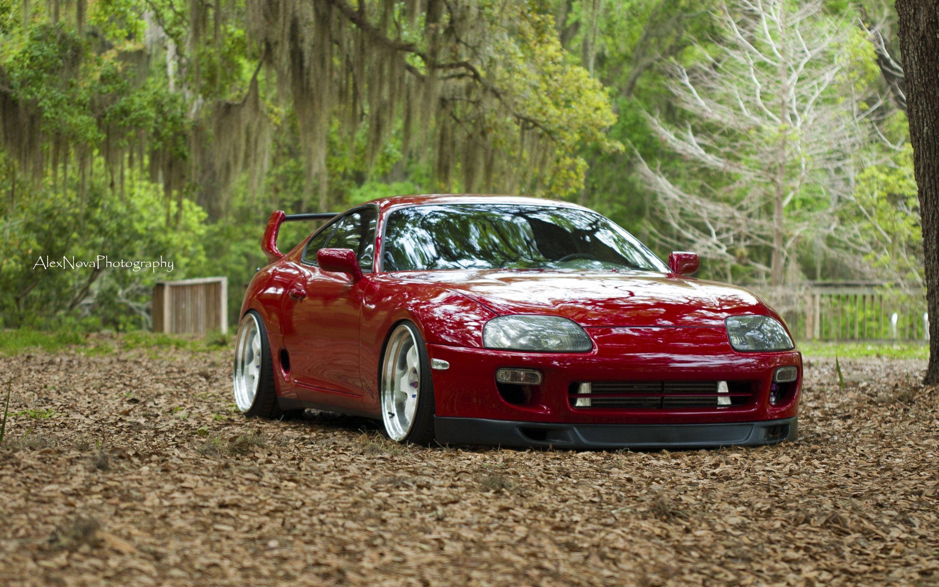 1994 Toyota Supra Mk4, glossy red, pine needles, 2K Desktop Wallpaper