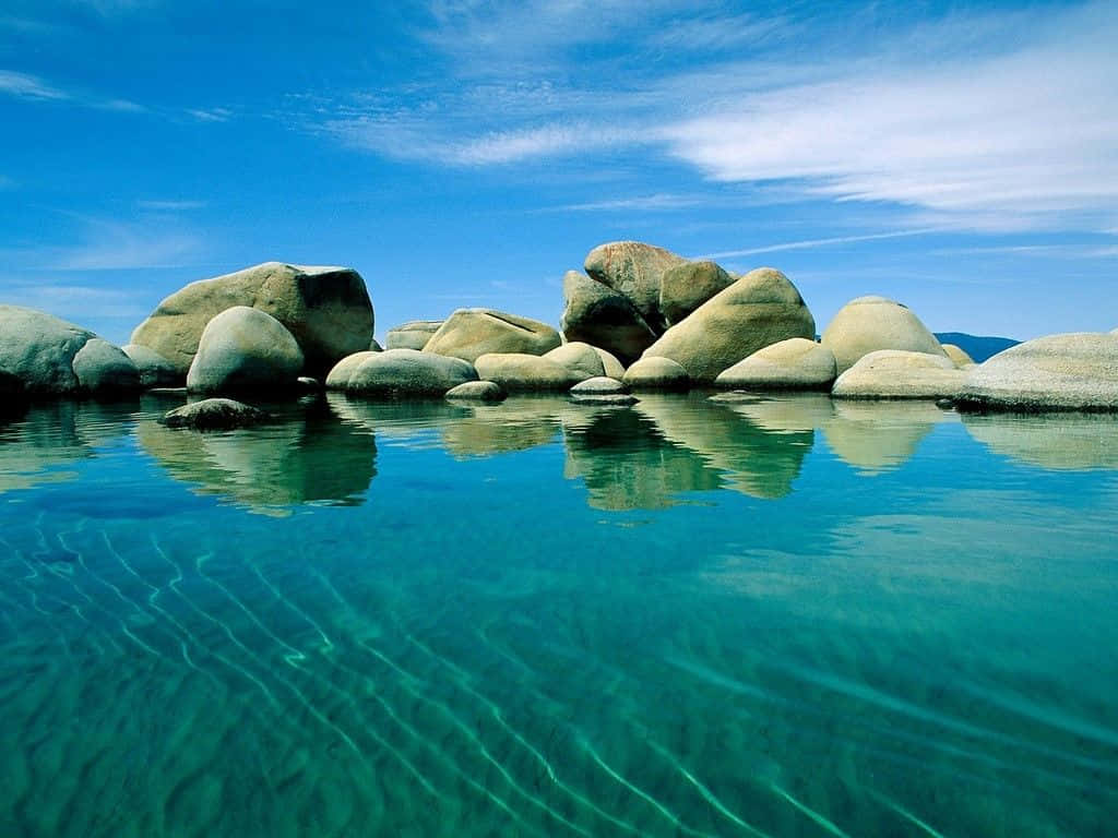 turquoise water, smooth rounded boulders, bright blue sky, SD Desktop Wallpaper
