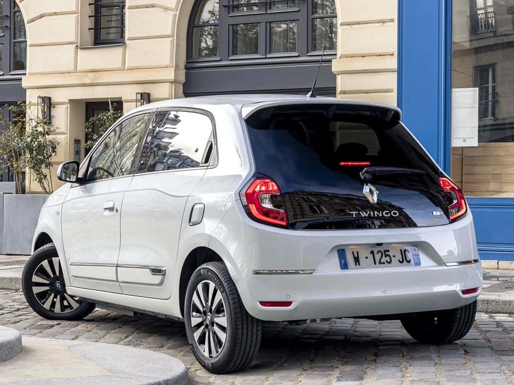 White Renault Twingo, cobblestone street, beige building, SD Desktop Wallpaper