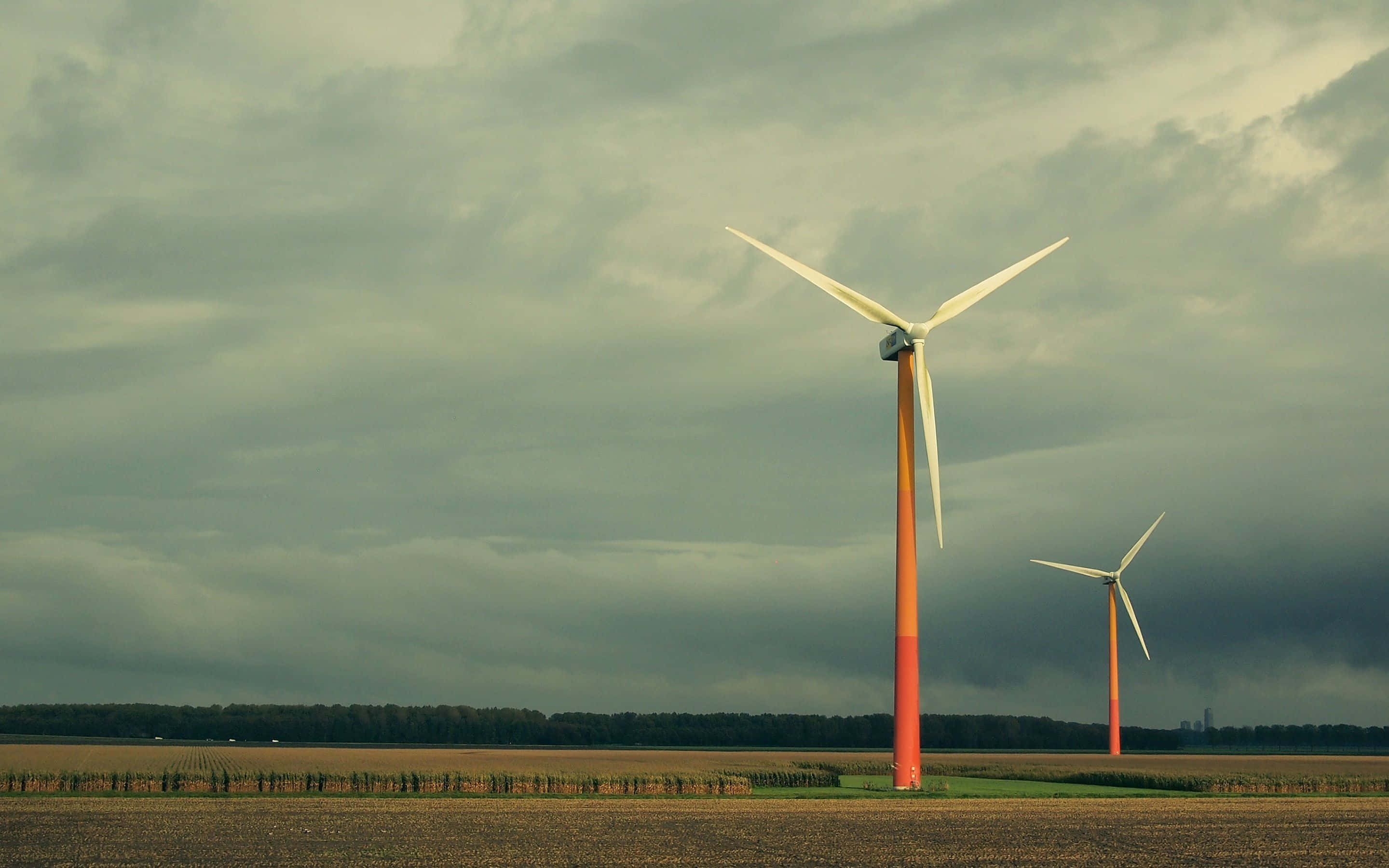 wind turbines, vast field, heavy overcast sky, 2K Desktop Wallpaper