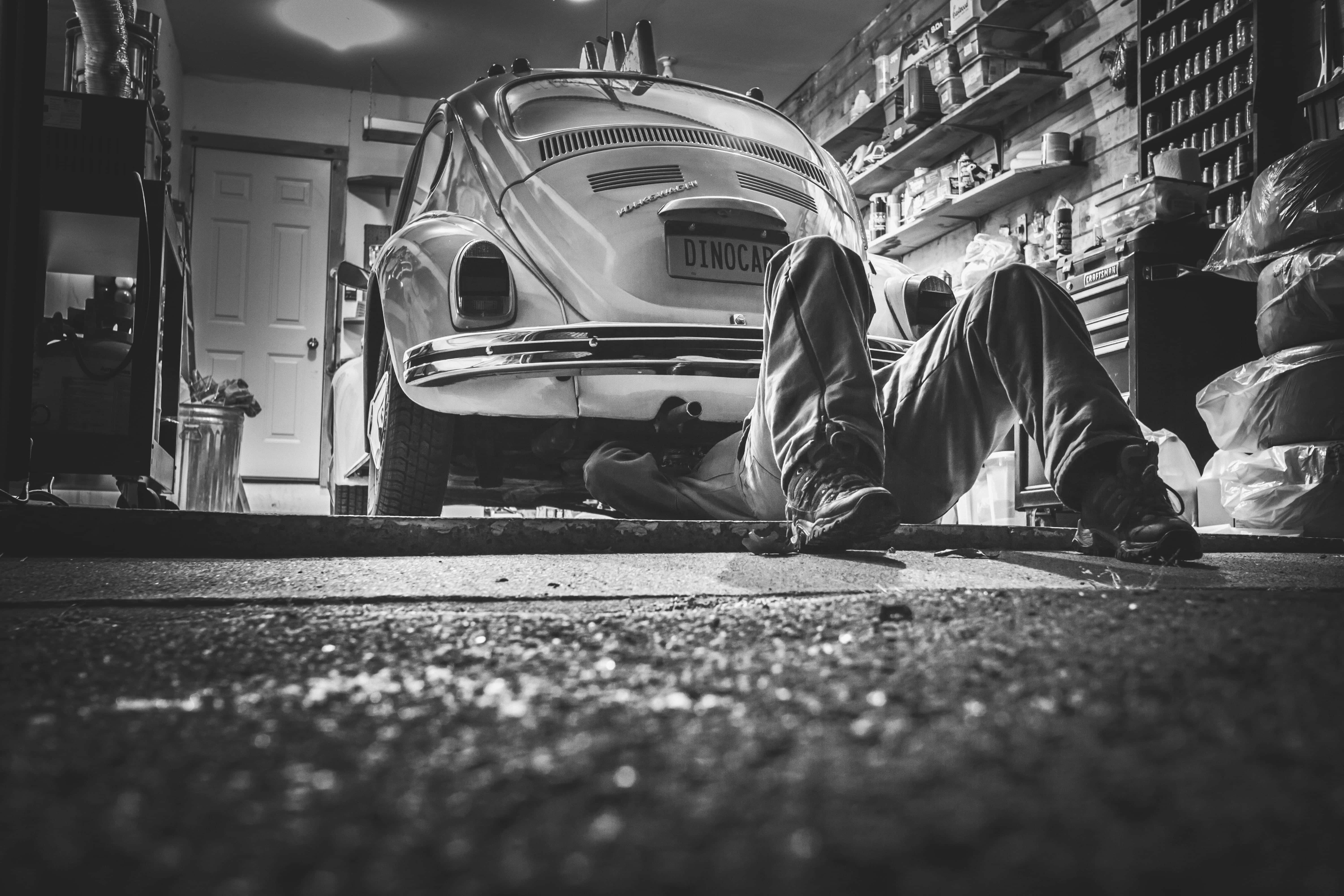 vintage Volkswagen Beetle, cluttered garage, shelves of parts, 5K Desktop Wallpaper
