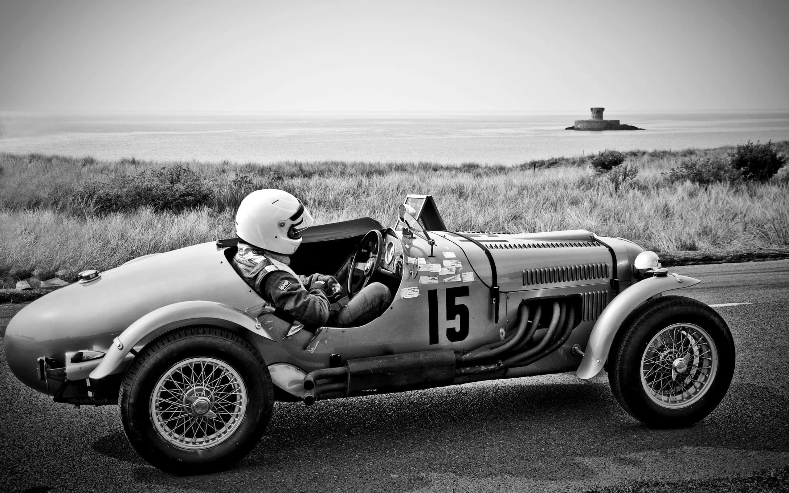 vintage race car, driver number 15, coastal road, 2K Desktop Wallpaper