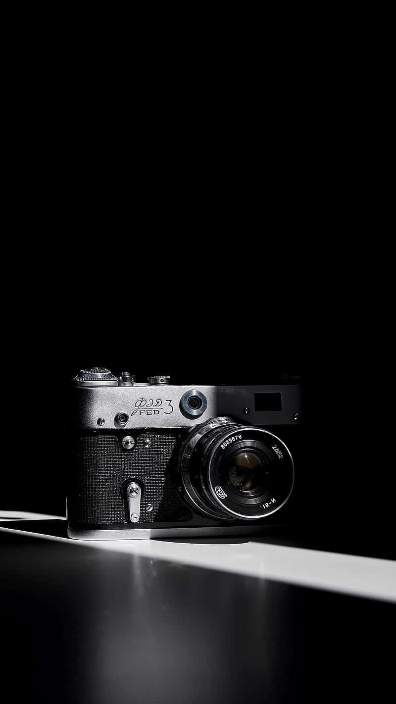 vintage silver film camera, reflective surface, dramatic spotlight, HD Phone Wallpaper