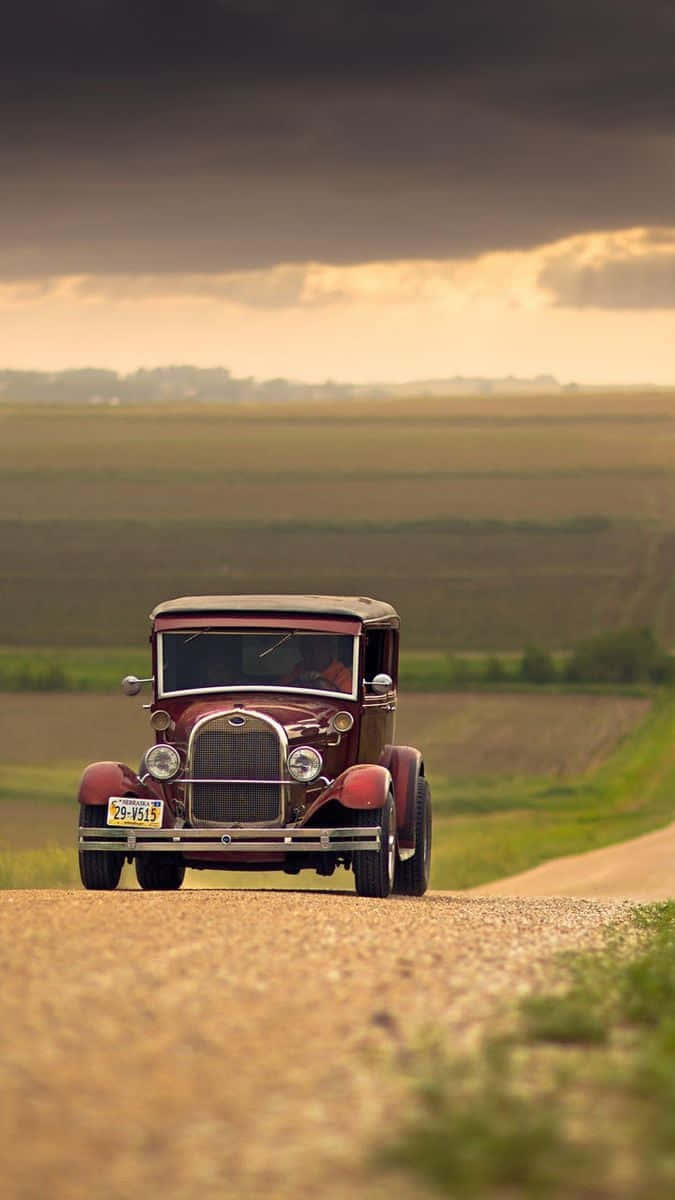 retro iPhone, vintage maroon car, gravel road, SD Phone Wallpaper
