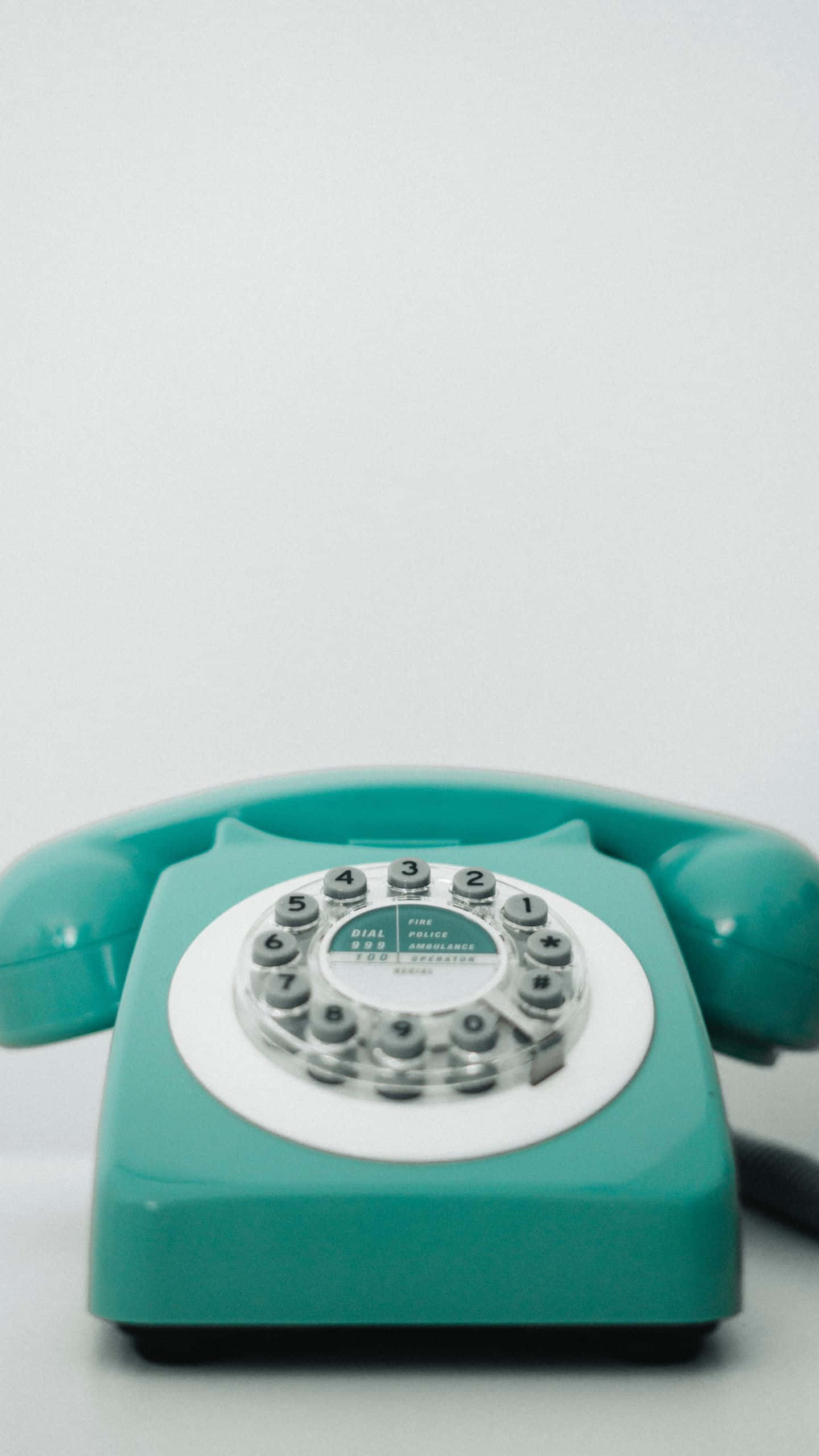 teal rotary telephone, white dial, plain white background, 2K Phone Wallpaper