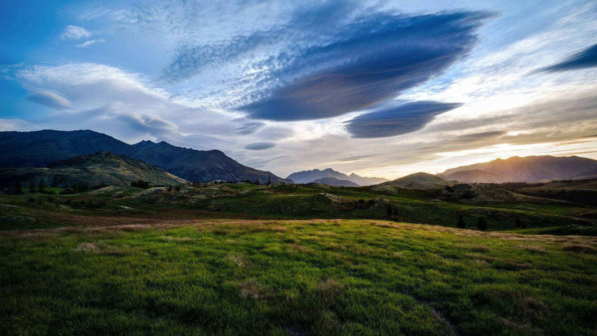 green meadow, distant mountains, dramatic sky, Full HD Desktop Wallpaper