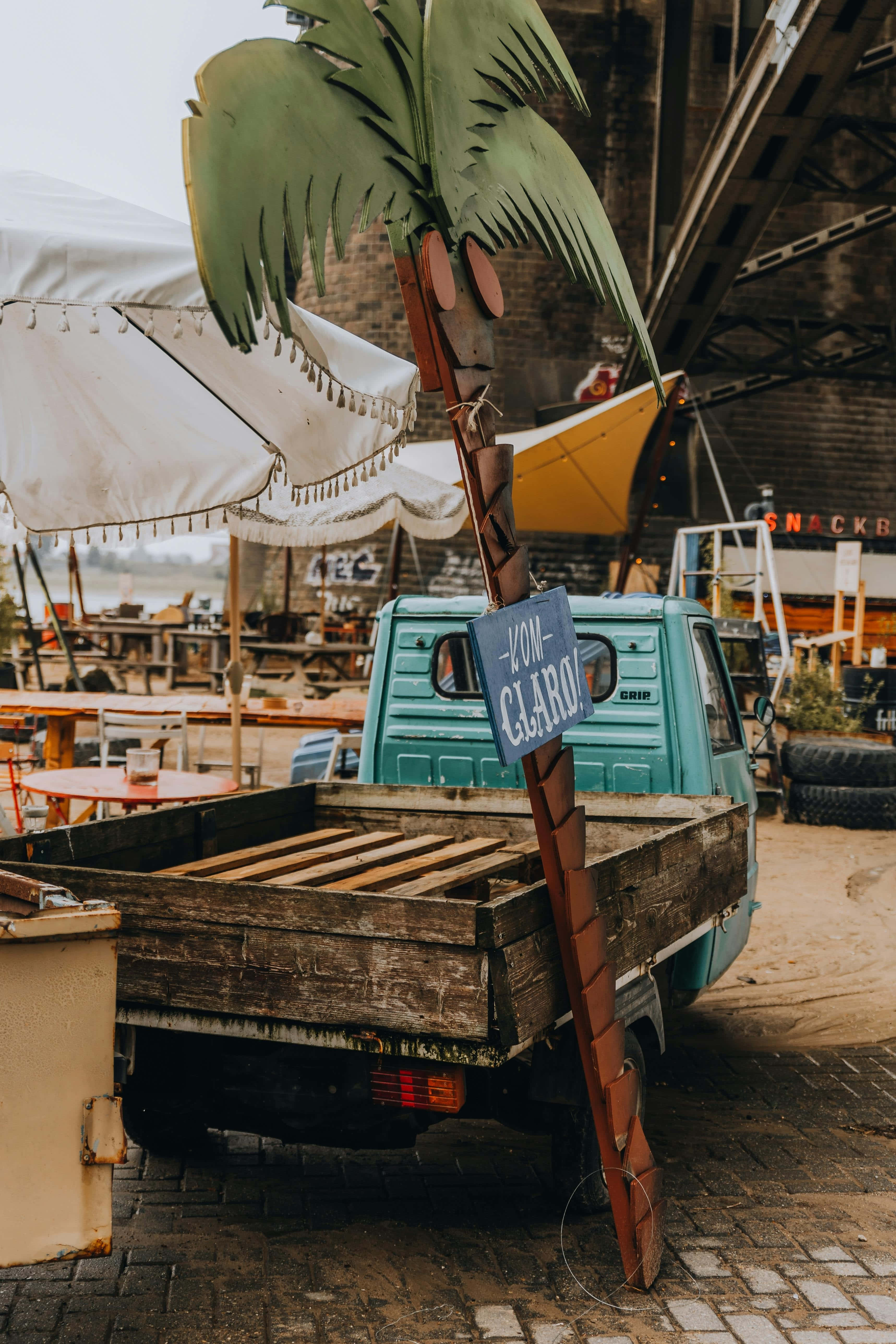 turquoise pickup truck, wooden bed, decorative palm tree sign, 5K Phone Wallpaper