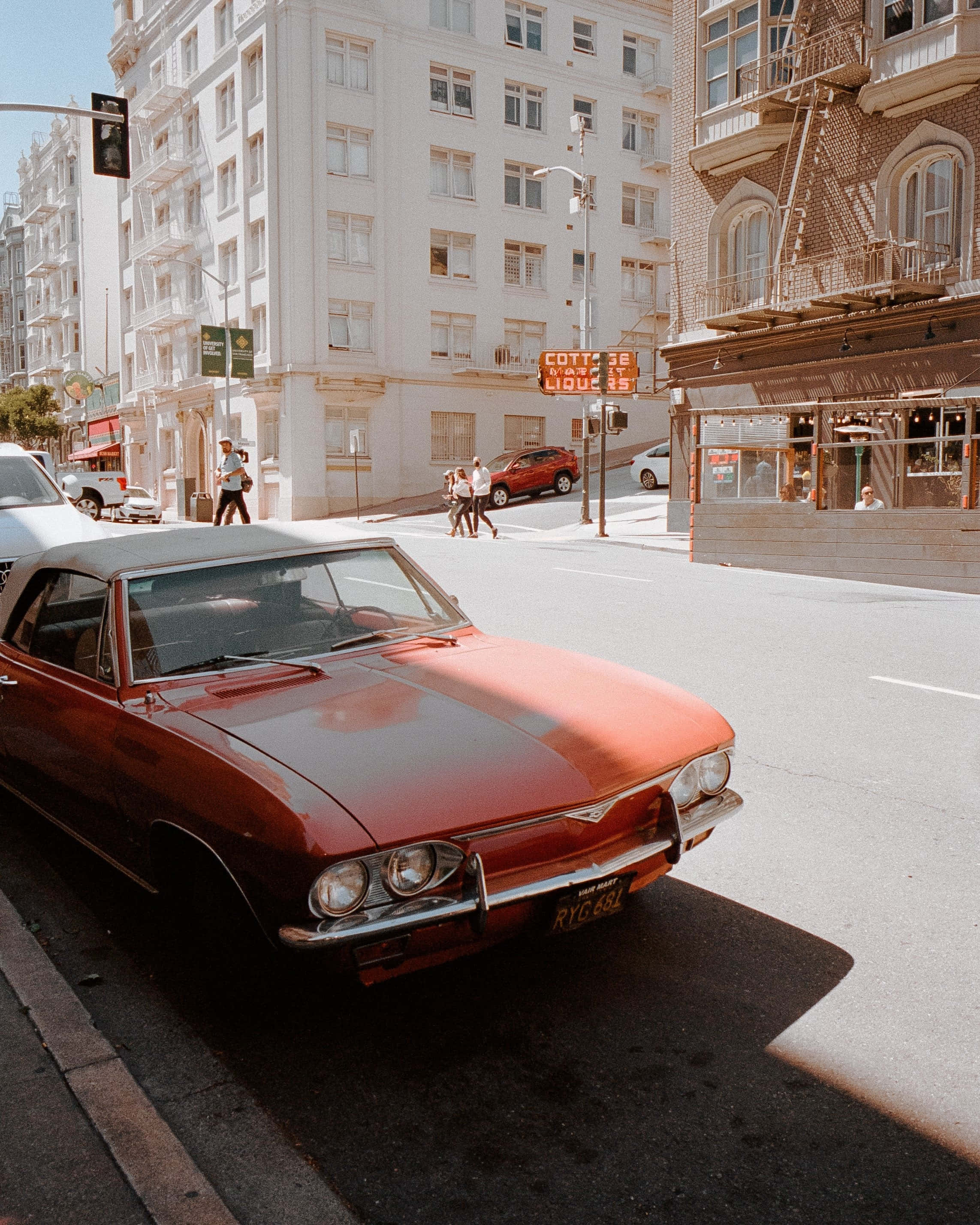 vintage red convertible, sunlit San Francisco street, pedestrians, 2K Phone Wallpaper