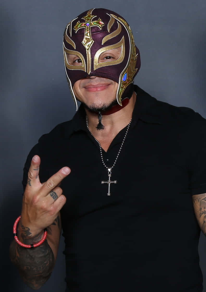 Rey Mysterio, maroon and gold ornate mask, rock hand gesture, SD Phone Wallpaper