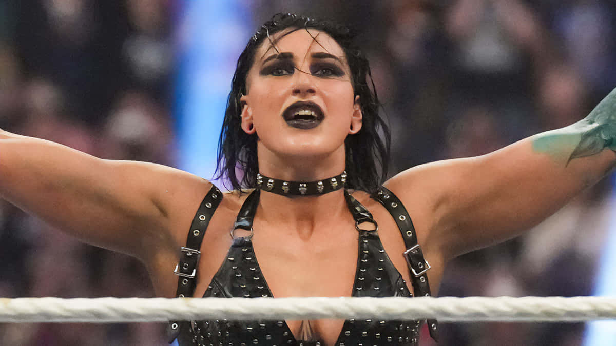 Rhea Ripley, wrestling match victory pose, black studded outfit, SD Desktop Wallpaper
