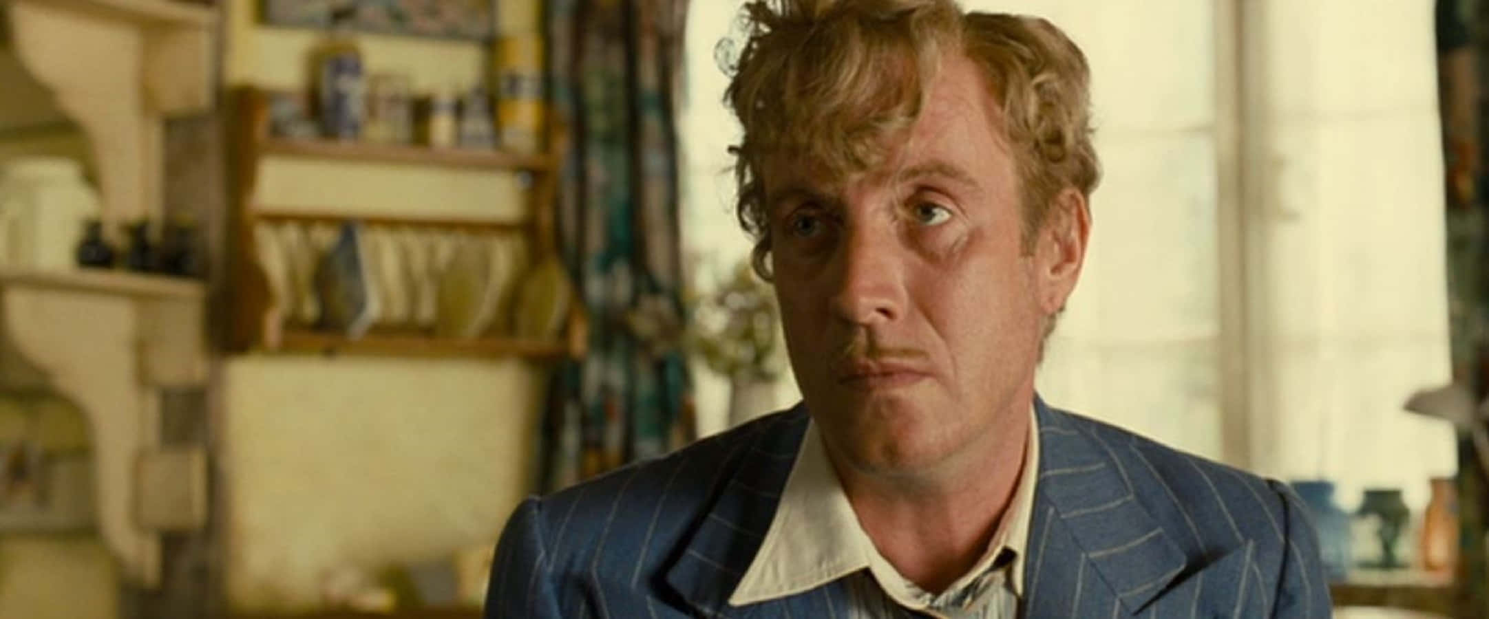 Rhys Ifans, blue pinstripe suit, warmly lit cluttered room, Full HD Desktop Wallpaper