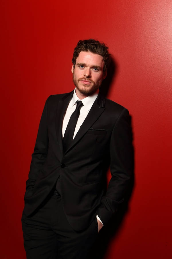Richard Madden, black suit, bold red wall, SD Phone Wallpaper